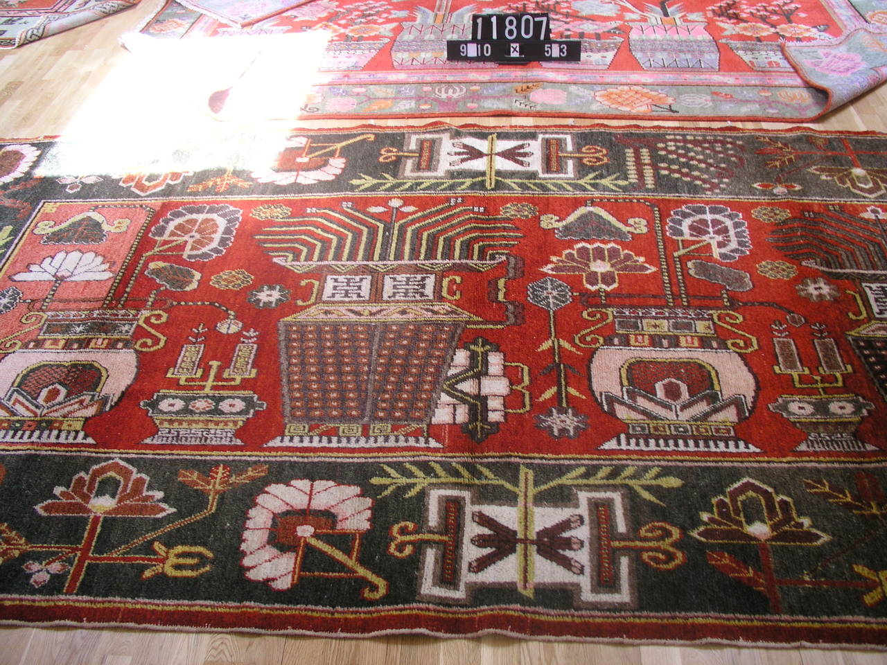 Antique pictorial Yarkand rug. The design depicts Art Deco period vases and motifs . Many Yarkand rugs tend to pictorial with Chinese details, Central Asian design schemes and Western vivid coloring.  This rug is woven using horse hair and wool,