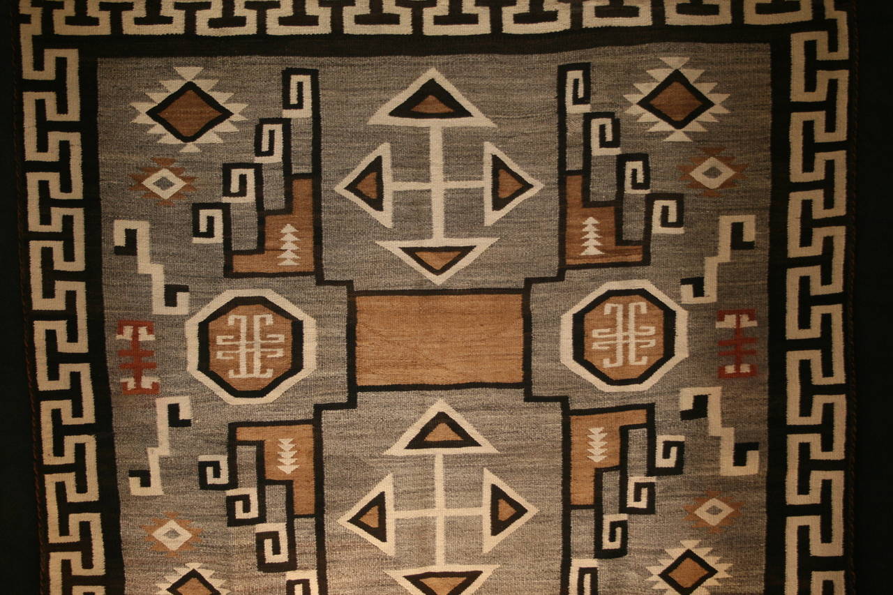 This is the best example of a square lightning bolt storm pattern two gray hills weaving. The Navajo weavers consider this pattern to be a sacred design. It shows the direction of the four sacred mountains. The square format is very important in