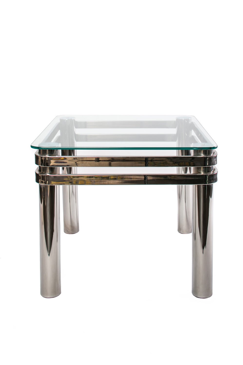 1970s chrome and glass side table with molded chrome wraparound accent. Tubular legs in Classic form of that era and creates a strong statement piece.