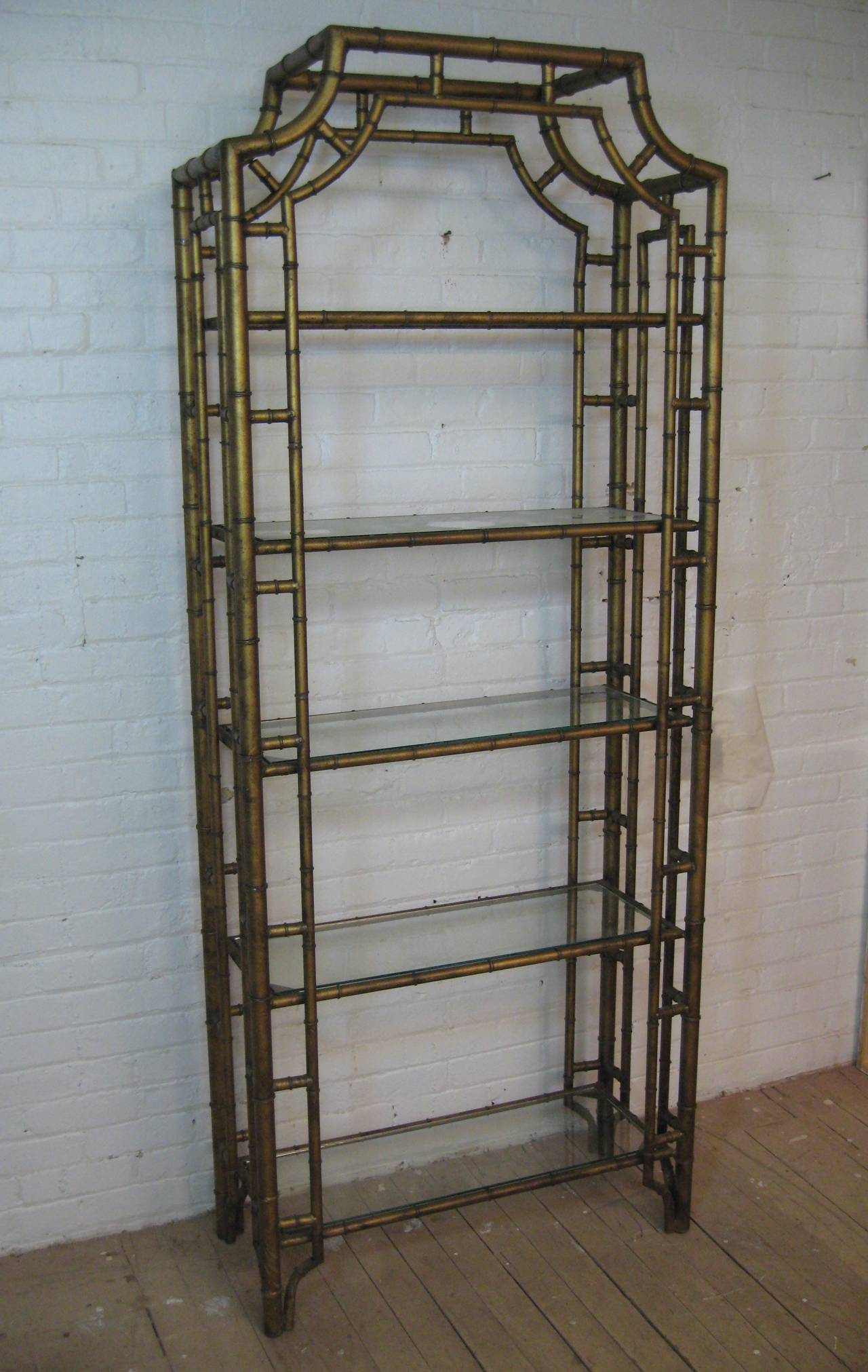 Elegant Chinese Chippendale style glass and metal etagere. Gilded and aged metal frame holds five glass shelves.