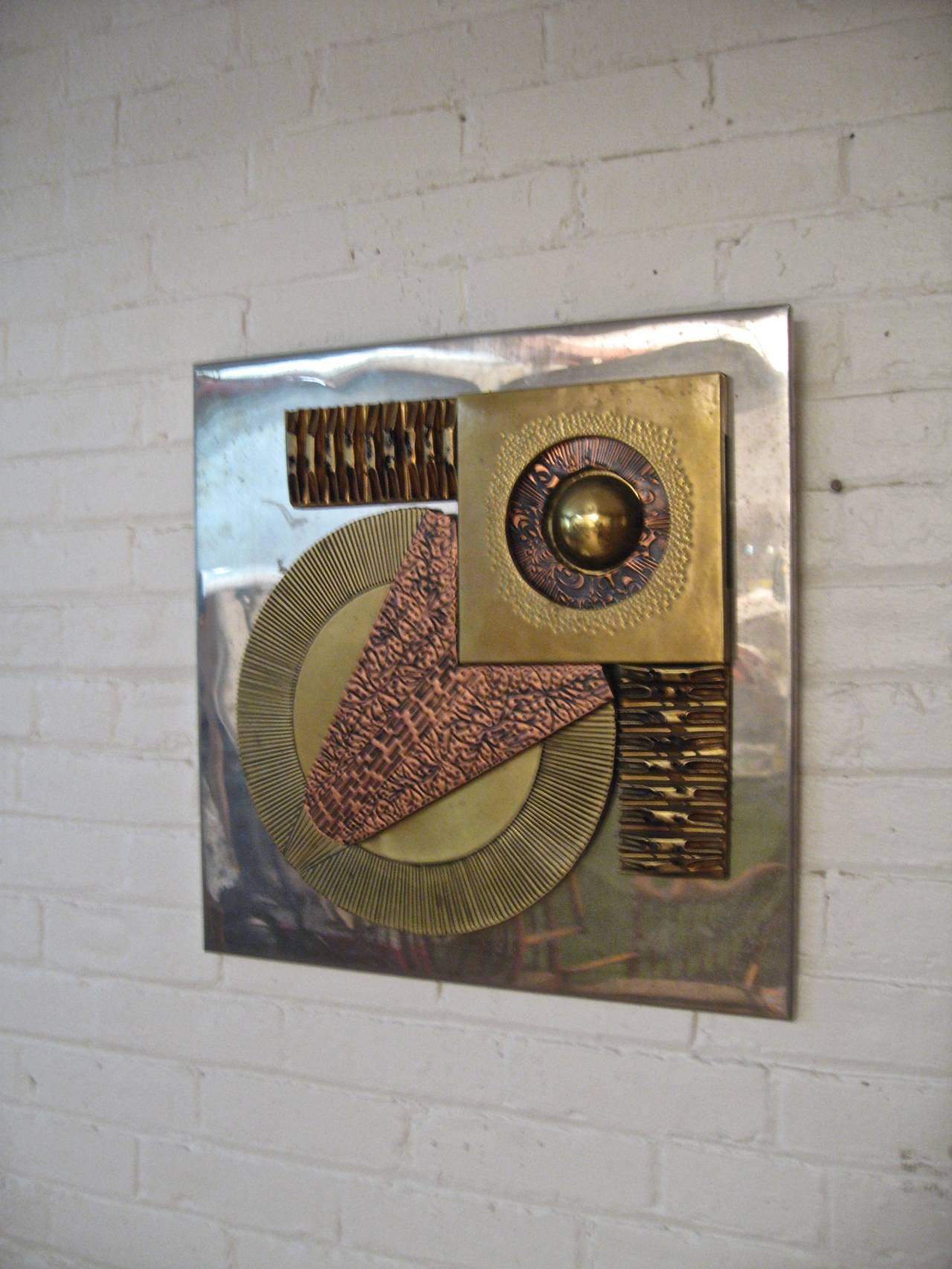 Geometric Brutalist mixed metals wall hanging.  Made of copper, brass, aluminum and steel.  Circa 1970-80. Excellent, original condition.  Unsigned.  Rendered in the manner of Curtis Jere,