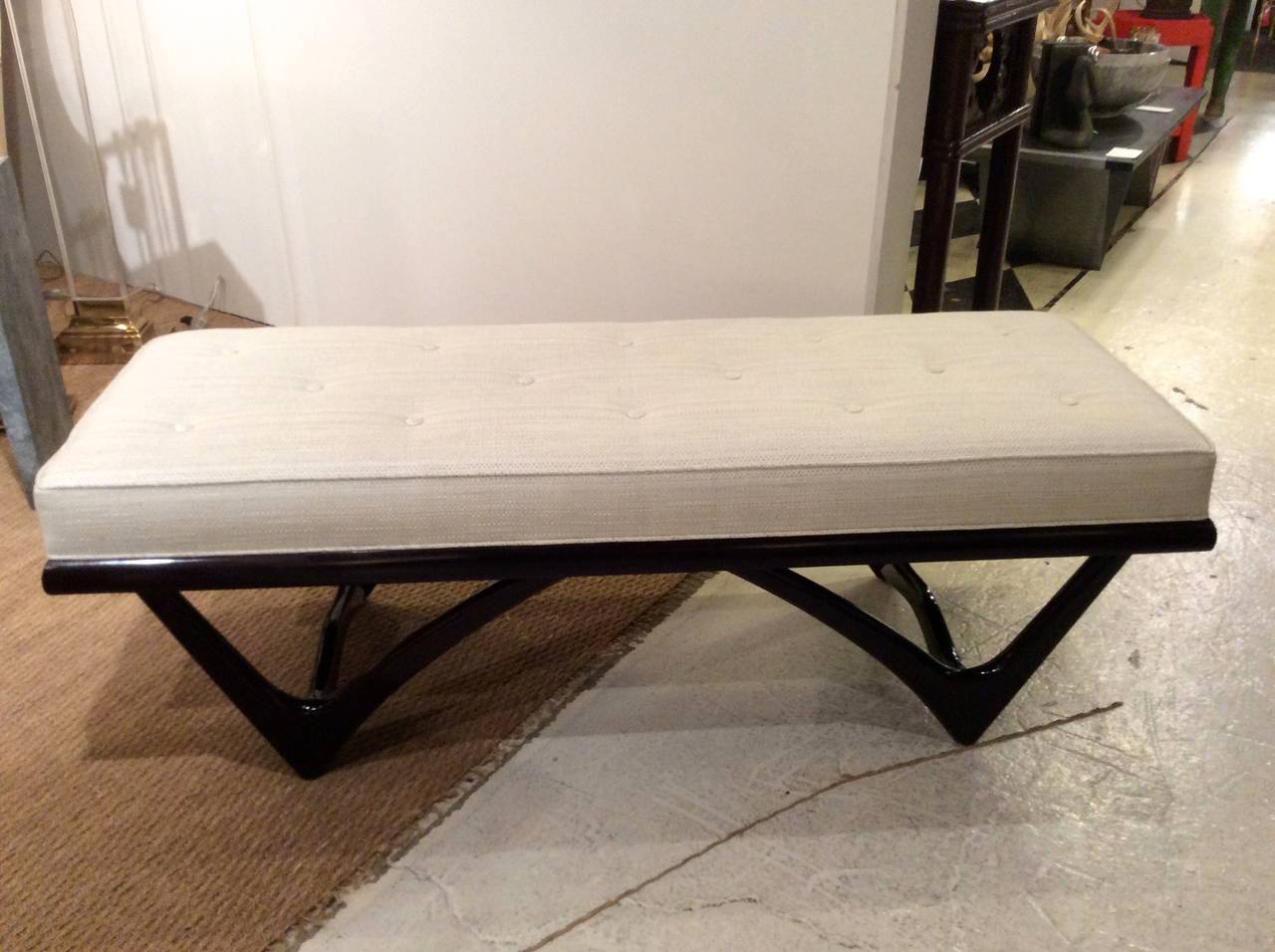 Newly refinished frame in a rich dark sable stain and gloss finish. Sculptural Frame in style of Adrian Pearsall or Kagan style bench is button tufted and beautifully finished in contrasting cream tweed woven fabric.