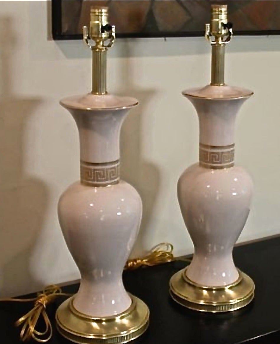 Glazed ceramic body are adorned with gold Greek key design and solid brass fittings. Beige ceramic bodies and shade. Custom matched tonal shades also trimmed in gold. All are in great condition and have been recently polished and lacquered. Rewired.