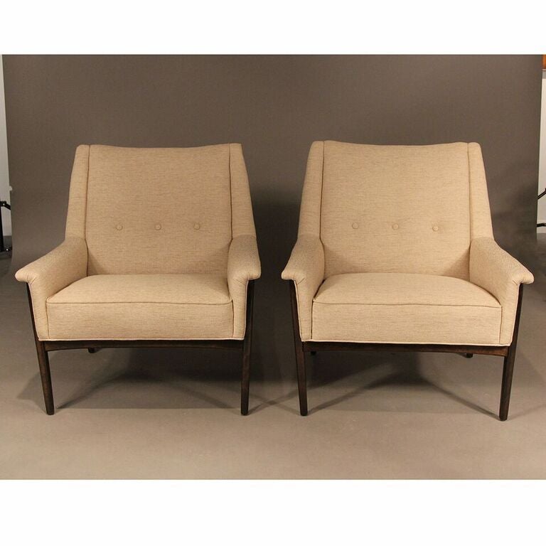 Stylish Danish modern pair of lounge chairs, by Folke Ohlsson for DUX. Three button detail on back and newly reupholstered in a neutral woven fabric. Chairs have been completely restored or refinished in a chocolate brown stain, and are in excellent