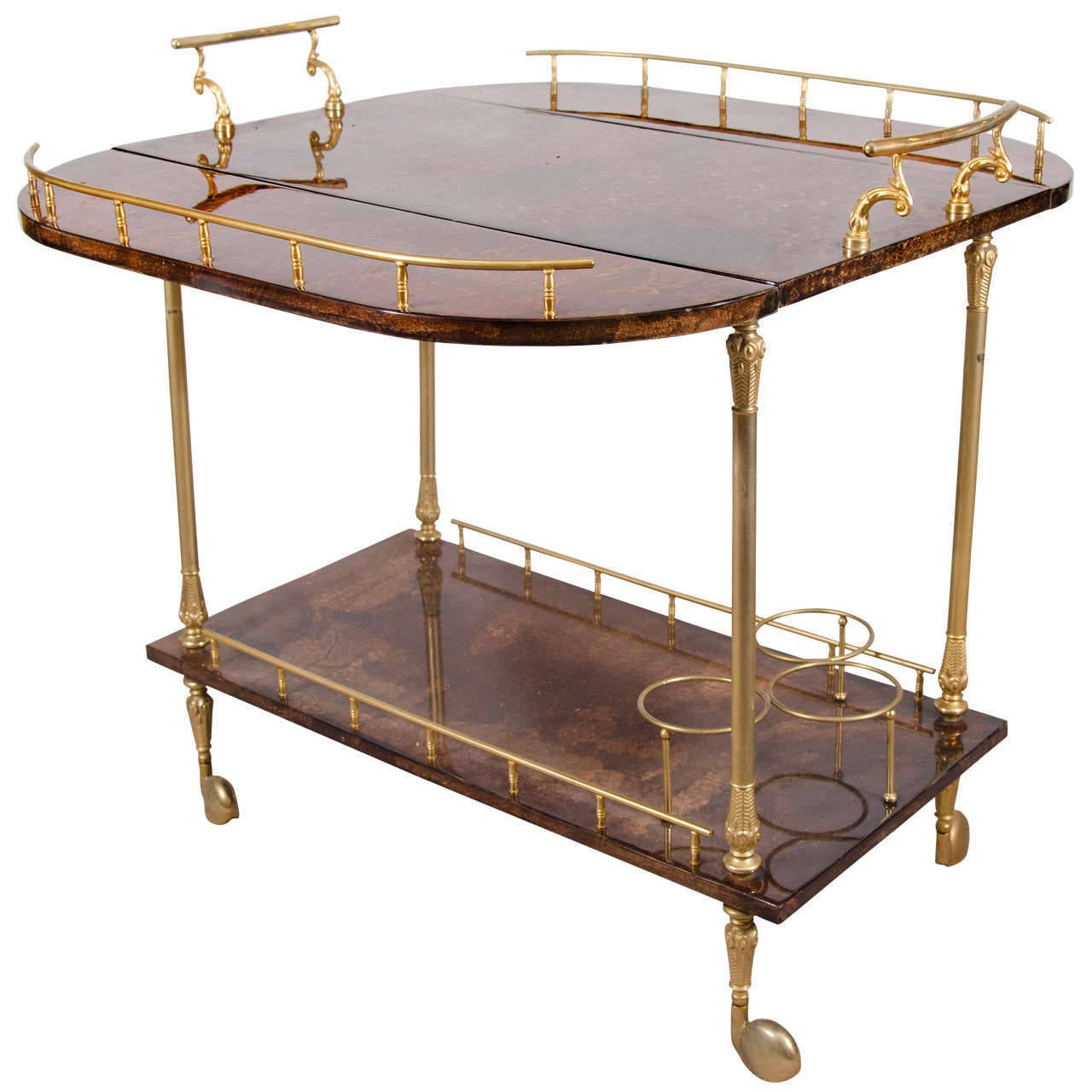 A nearly pristine example of a vintage Aldo Tura bar cart in elegant polished brass and mottled chocolate brown lacquered goatskin with fold down sides, and three wine or bottle holders. 
Fold size: 30 L x 17