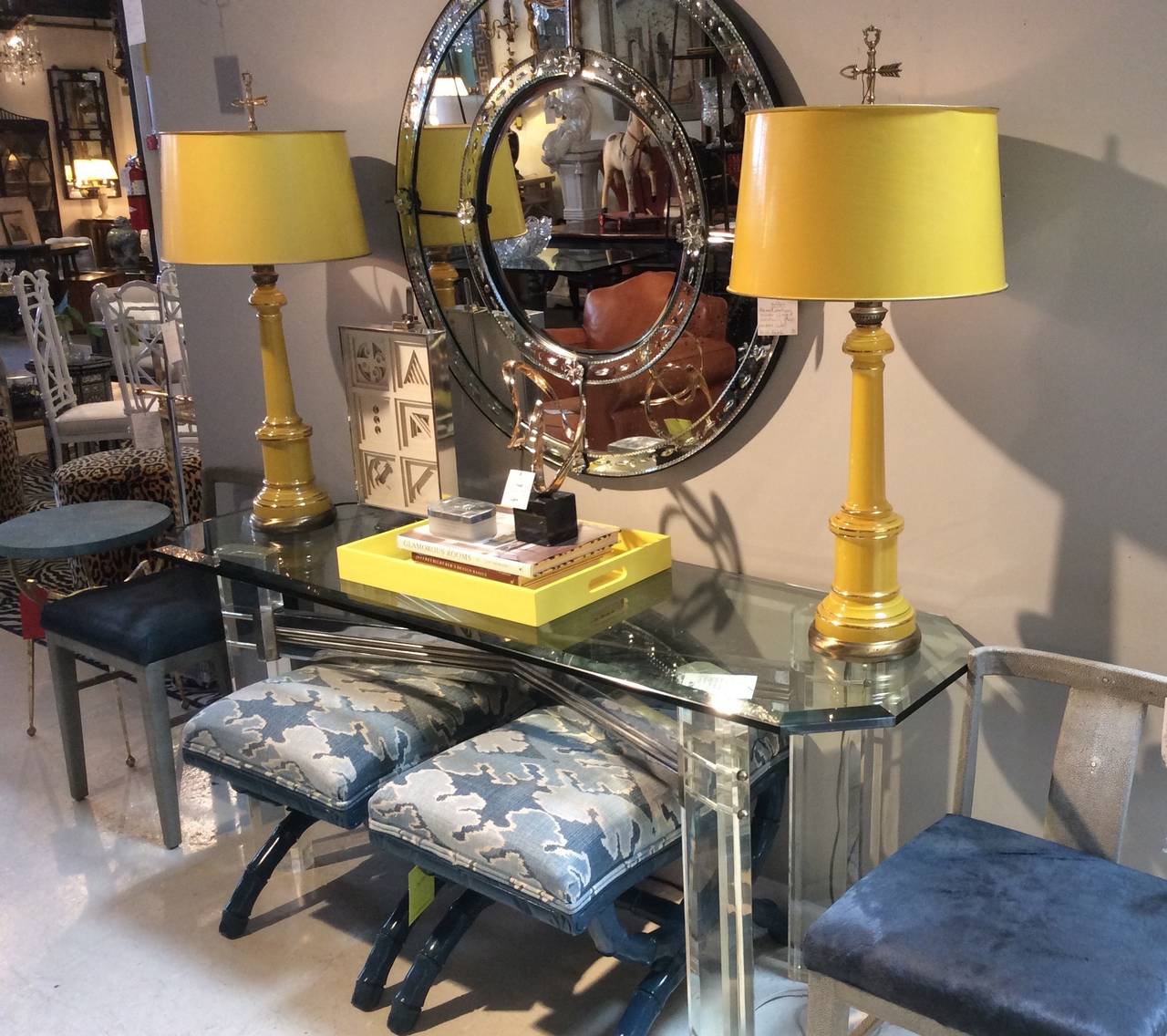 Vibrant and striking yellow pair of table lamps by Warren Kessler of New York. Reverse painted yellow glass body with gilt pinstripe detail. Brass base, stem, arrow finial and amazing colored coordinating shade with gold trimmed rolled edge