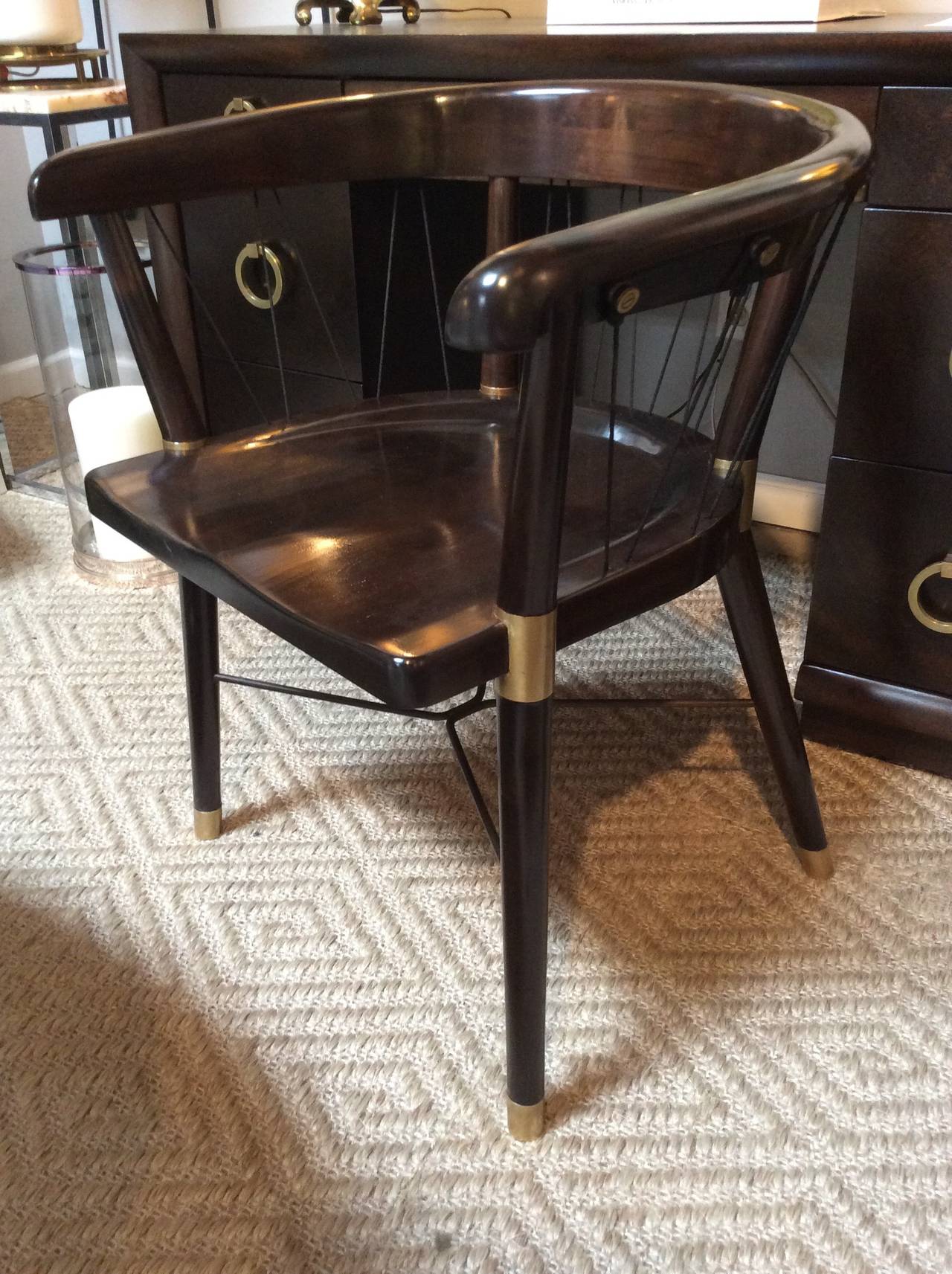 Extremely rare captain's style chair by Edward Wormley. Adorned with stunning brass screw mountings securing cord strung around the horseshoe shaped back. Brass capped feet and brass detailing where seat attaches to legs. Chair has been completely