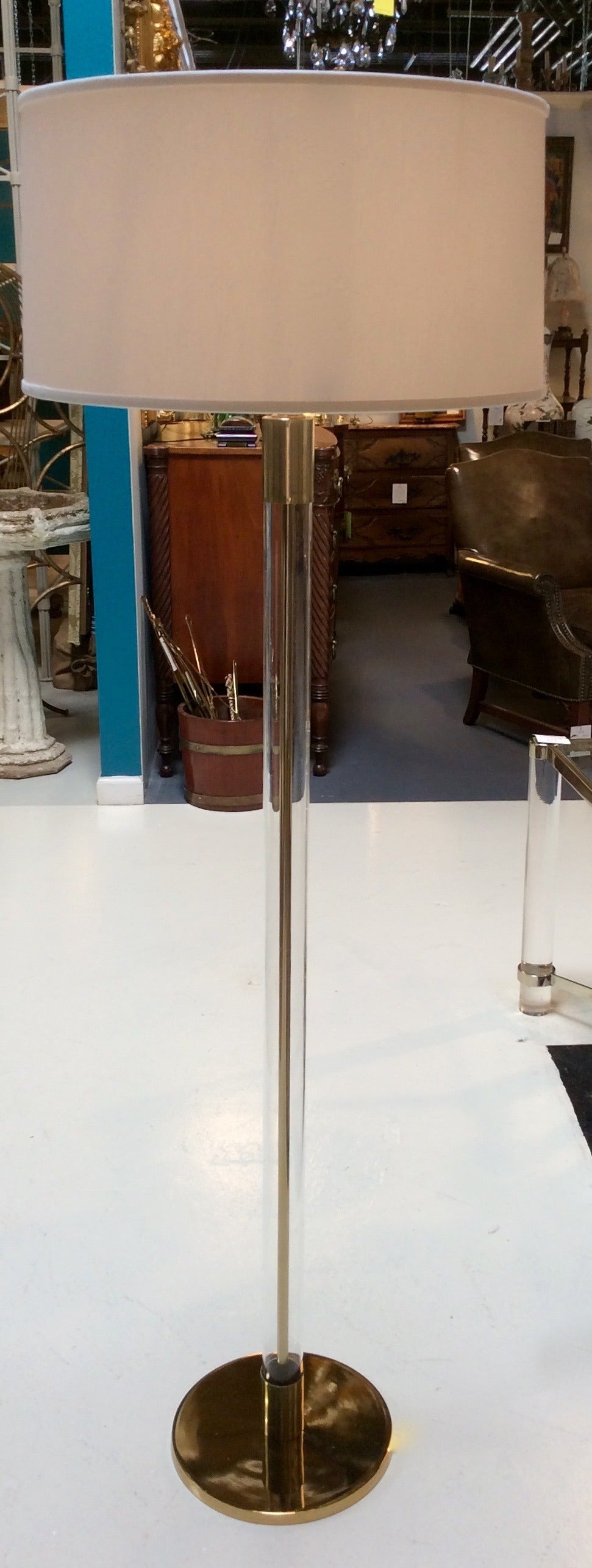 Fabulous vintage pair of glass and brass pole floor lamps, capped on either end with brass spacer and brass base.
Newly rewired and new sockets.
Manner of Hansen Lighting Co., NYC.