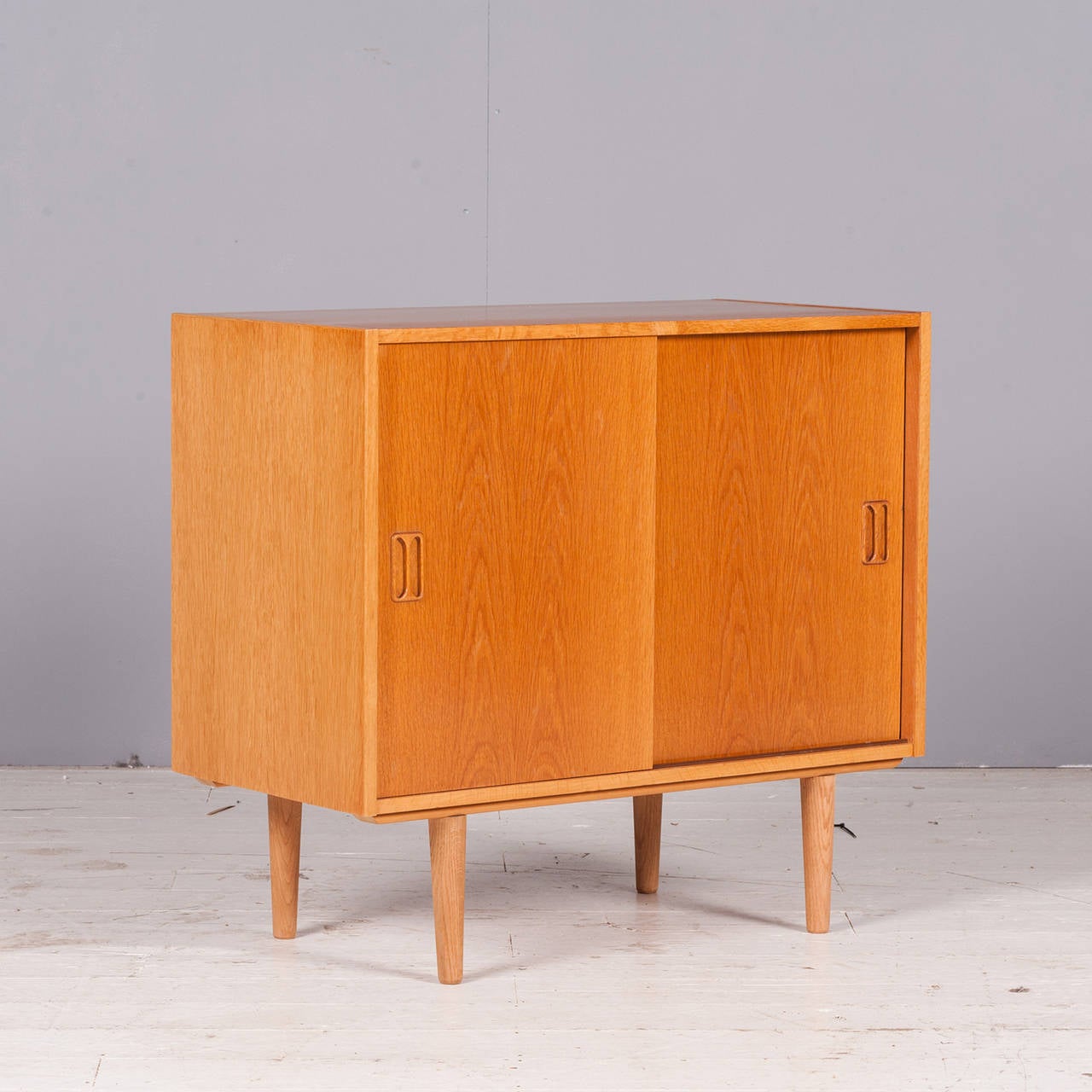 A beautiful Danish sideboard in oak with smooth sliding doors. This piece was made in the 1970s and has been restored to perfection. The perfect size for a smaller space!