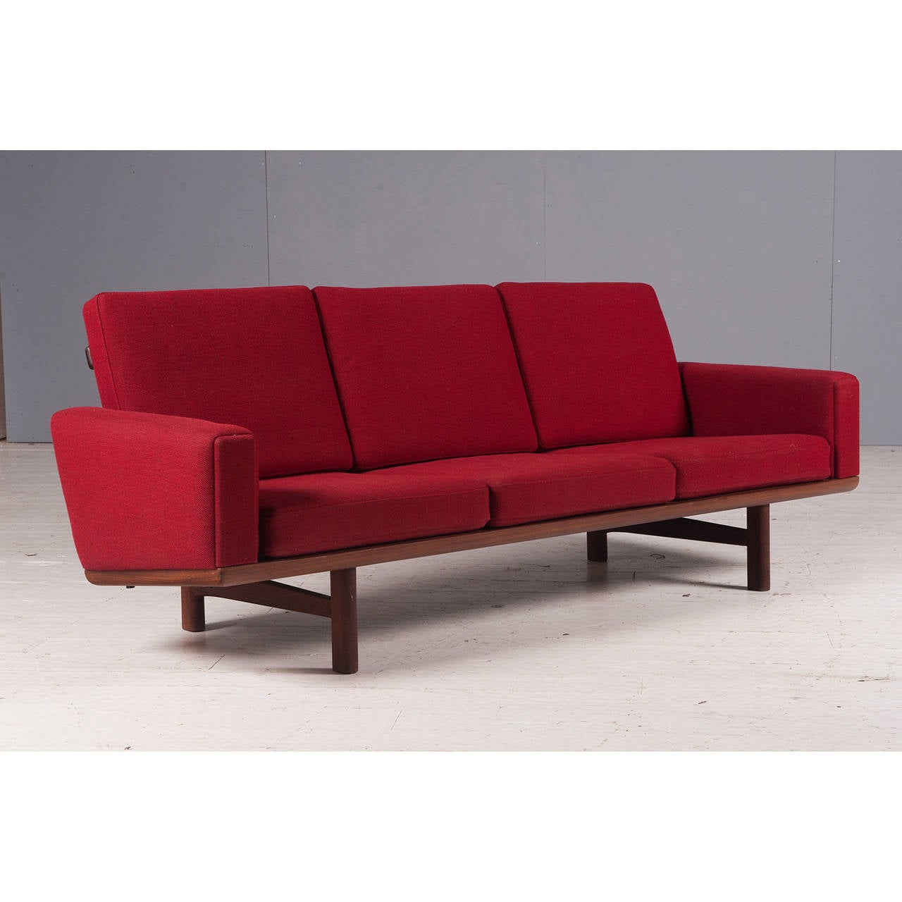 Hans Wegner believed furniture should be beautiful from every angle and the GE-236 is fine example of this. With it's exposed timber backing, this sofa would look stunning as the central feature of a room. 
This is a design classic in its original