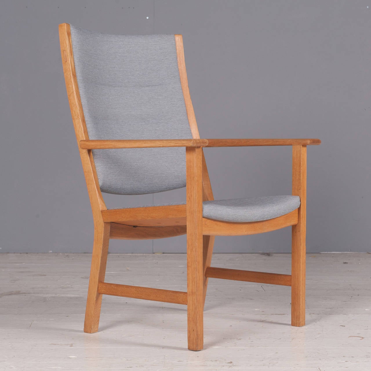 A superbly comfortable armchair designed by Danish icon, Hans J. Wegner. Newly upholstered in gentle grey instyle fabric and fully restored in Melbourne. A wonderful armchair or perhaps an indulgent dining chair!