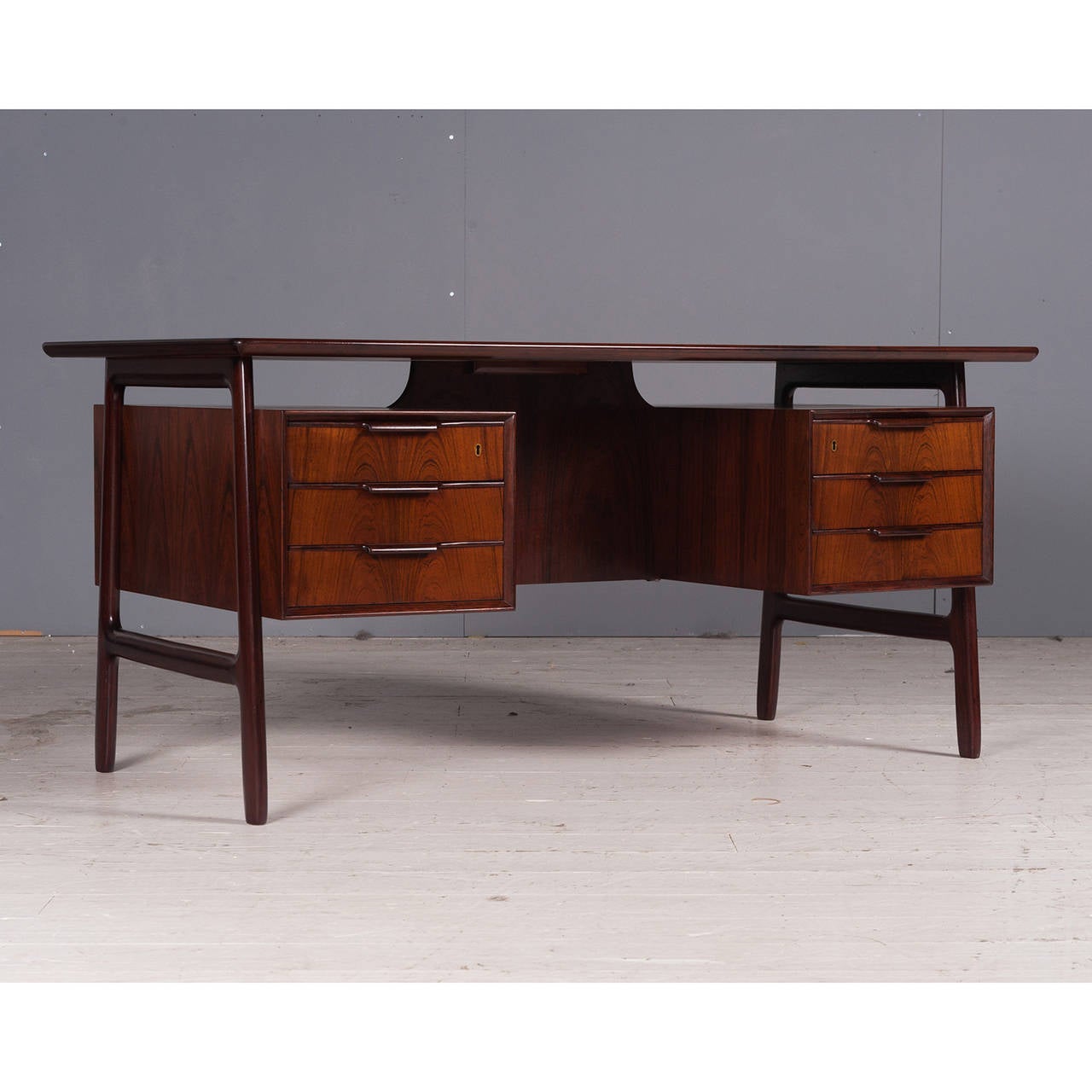 Designed by Gunni Omann and manufactured by Omann Junn in Denmark, this this stunning 1960s Rosewood desk has been fully restored in Melbourne. It featured 6 spacious drawers and a beautiful floating desk top.