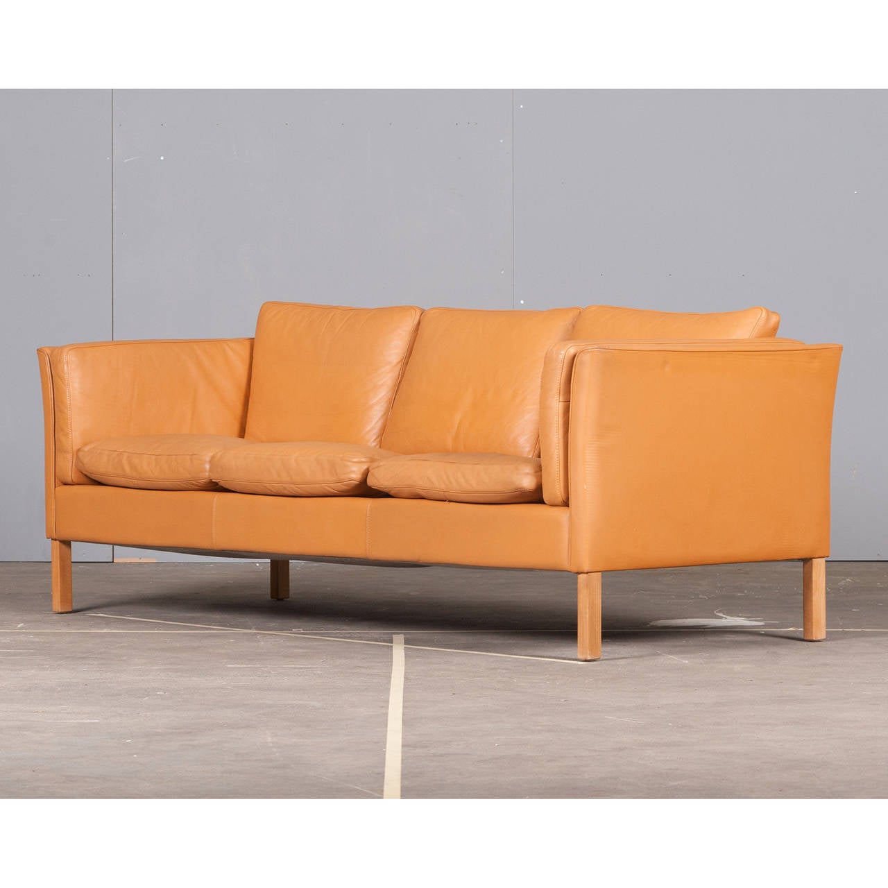 This Danish sofa is a classic and favourite style here at Modern Times.  With a beautiful honey-tan coloured leather, this sofa is both stylish and comfortable.

We are pleased to offer complimentary shipping on this item for customers based