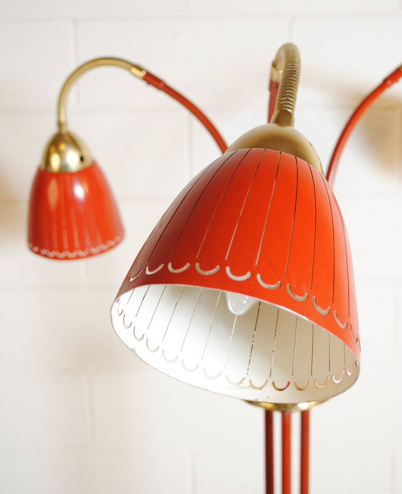 Mid-Century Italian Triennale standing lamp in the style of Stilnovo in red enamel and brass.
