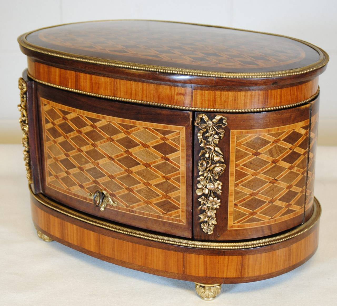 Signed antique French cased Tantalus set complete with decanter and glasses. The case in Mahogany and Kingwood with various fruitwoods in the parquetry inlay with stunning gilt bronze mounts. Signed to the lock plate 'Diehl Paris'. A beautiful