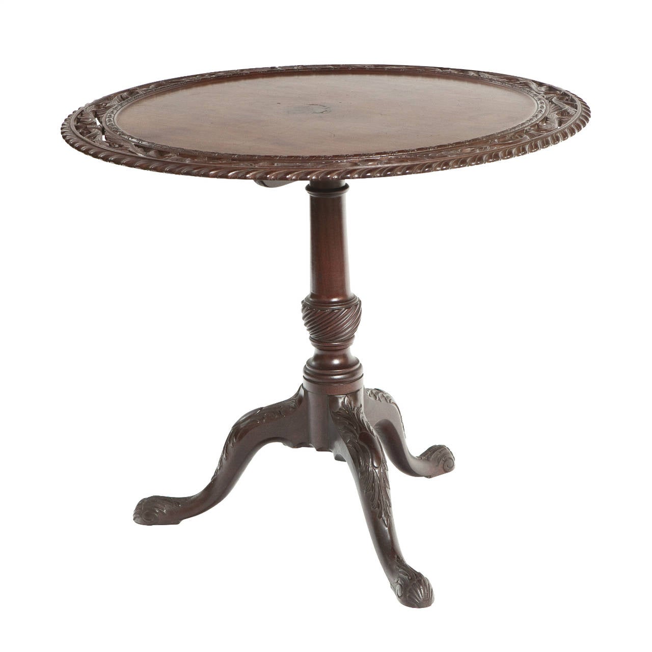 An absolutely stunning piece of furniture, this 18th century Irish mahogany table features a tilt top which has been expertly carved from a single piece of timber. With beautifully carved legs, and the tabletop boasting some gorgeous piercing, this