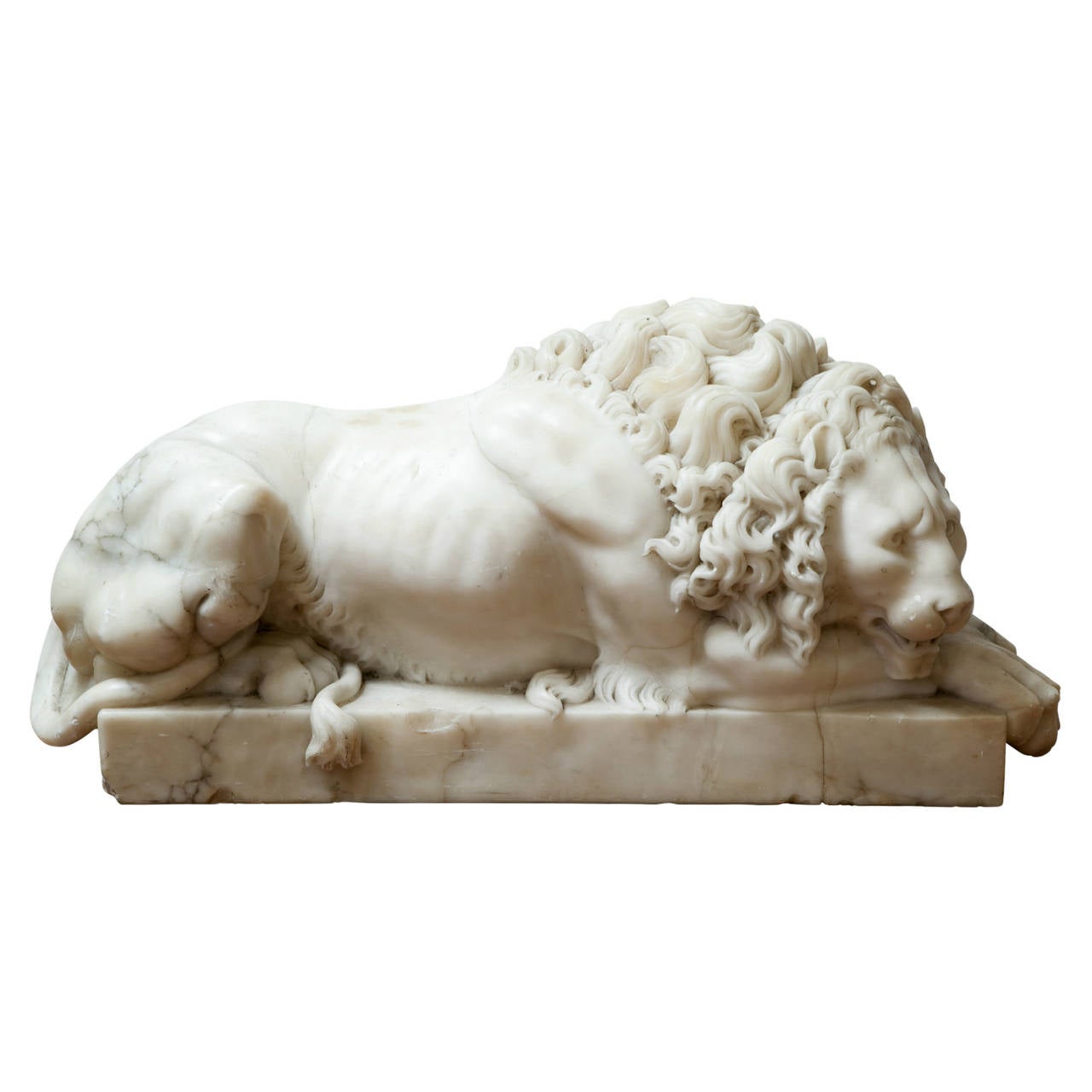 A pair of 19th Century hand-carved Carrara marble lions. These detailed pieces are based on a pair of sculptures that sit at the entry of Pope Clement XIII's monument in Vatican City, as sculpted by Antonio Canova in 1792. One lion is depicted