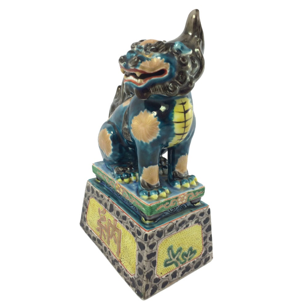 A pair of Japanese Kutani ware models of Komainu from the Meiji period (1868-1912). This pair features refined decorative enamelling and gilding. Komainu have a strong resemblance to Chinese Guardian Lions (Shishi), and it is believed that the