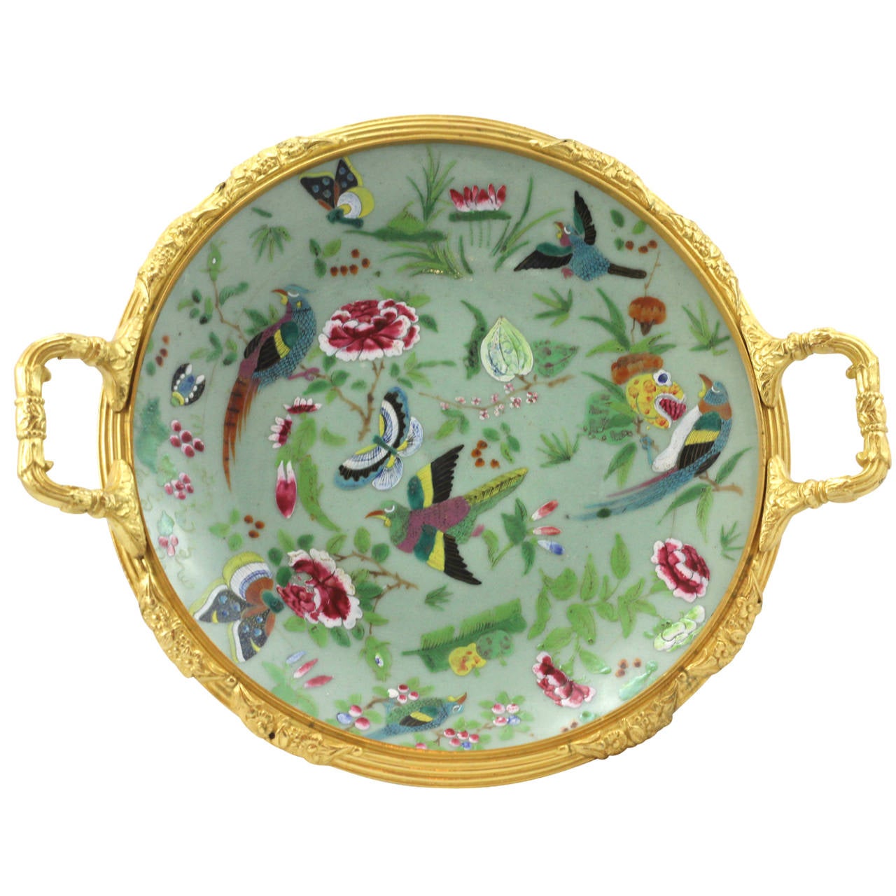 A colorful Cantonese celadon tazza with ormolu mounts. The piece is hand decorated with a painted enamel bird, butterfly, and floral motif. The ormolu itself has a distinct European influence, and was probably added after the pieces creation during