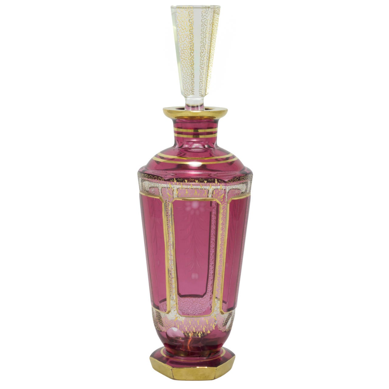 Pair of early 20th century ruby cut to clear bohemian glass decanters with gilt decoration. Each decanter sports individual design features, such as alternating cut panels, and varied gilt banding, to differentiate between spirits. These glass