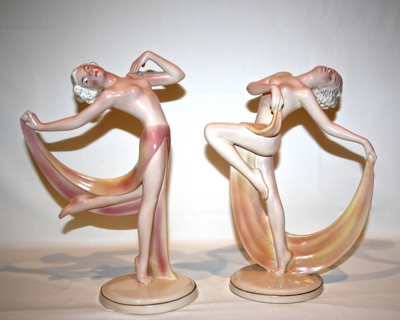 A stunning pair of semi clad nude scarf dancers - dramatic posers .
Made in the early 1930s by the firm Hertwig and Katzhutte Germany.
These models have been attributed to sculptor Josef Lorenzl.
The pair present in wonderful condition a mixture