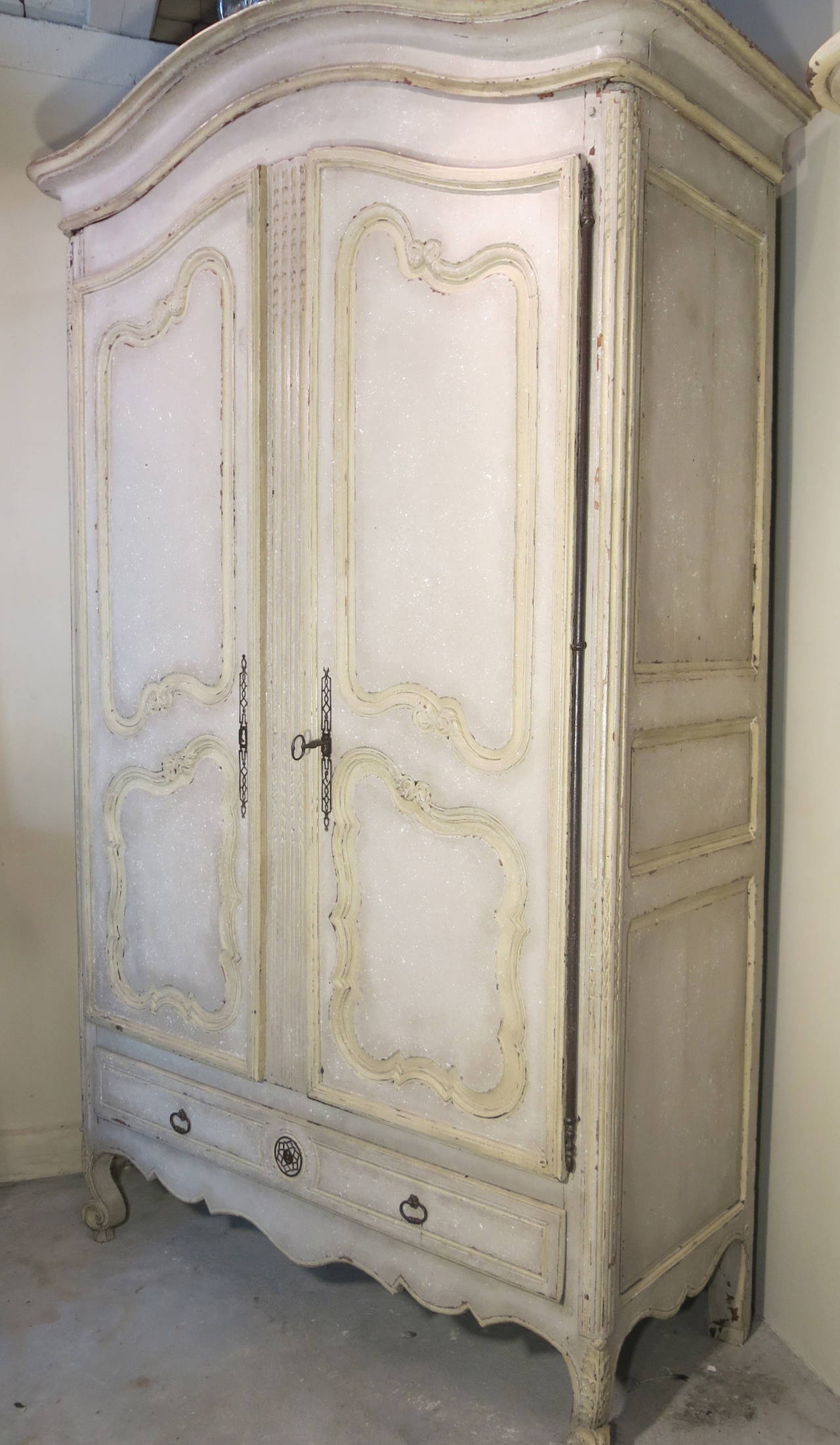 Extremely rare grand antique French period Louis XV walnut armoire, with curved bonnet, curved doors, rare drawer at the bottom, original grand pewter hinges and hardware and scalloped skirt from Provence.