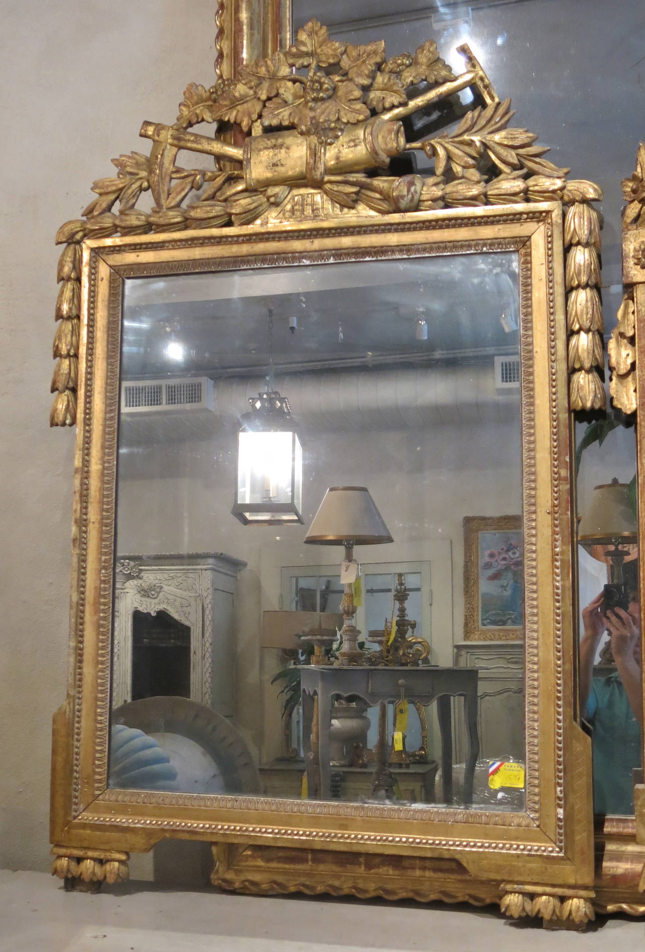 Antique French 18th century period Louis XVI mirror with gilded frame, detailed carvings and first generation mercury glass.