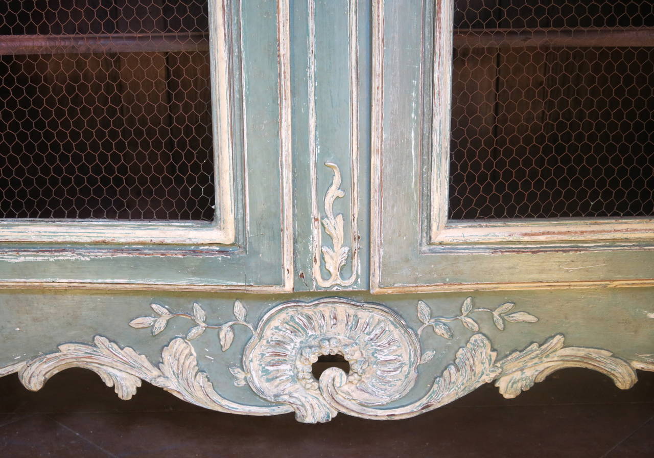 Grand antique French 18th century period Regence Louis XV Bibliothèque with detailed Carvings, French grill, French paint, scalloped shelves and original pewter hinges and hardware.