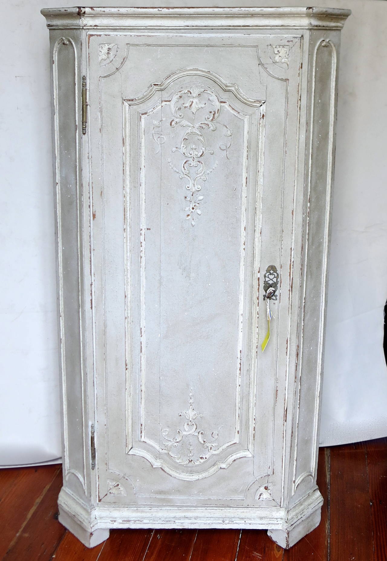 Antique French late 18th century-early 19th century encoignure (Corner Cabinet) with detailed carvings, original pewter hardware and French paint.