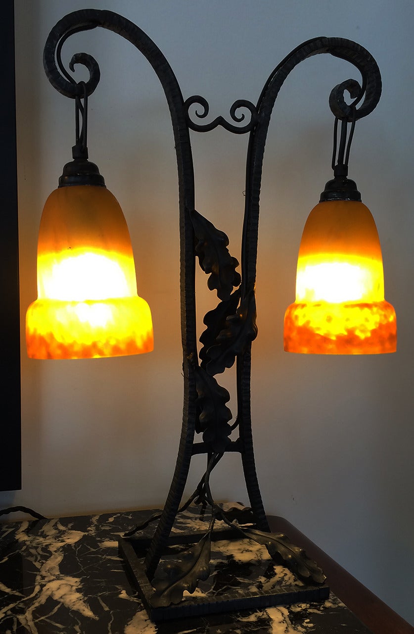 An Art Deco table lamp in iron with matching shades signed Croismaire. G.V. Croismaire GV de Croismare, Grand Verreries de Croismare was founded as part of Muller Freres. It was registered in 1928 by some of the Muller Freres brothers and produced