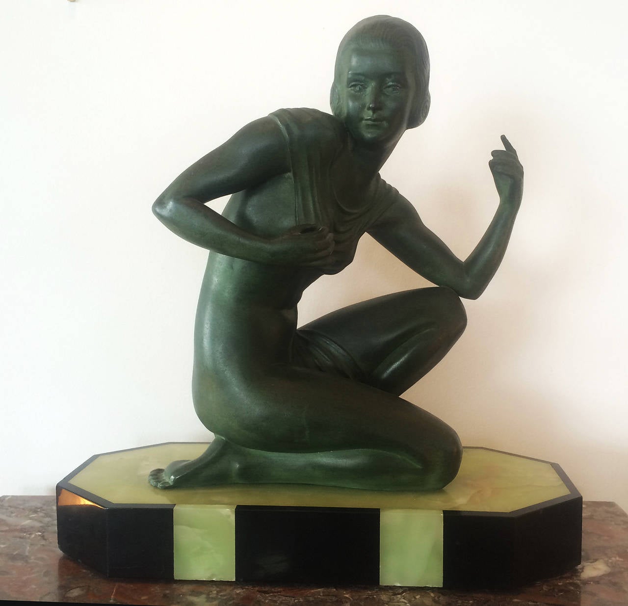 Art Deco bronze sculpture cast as a kneeling nude draped in a veil, on a green and onyx base, signed Scolisse. Sculptor was represented in the 1937 Colonial French exposition.