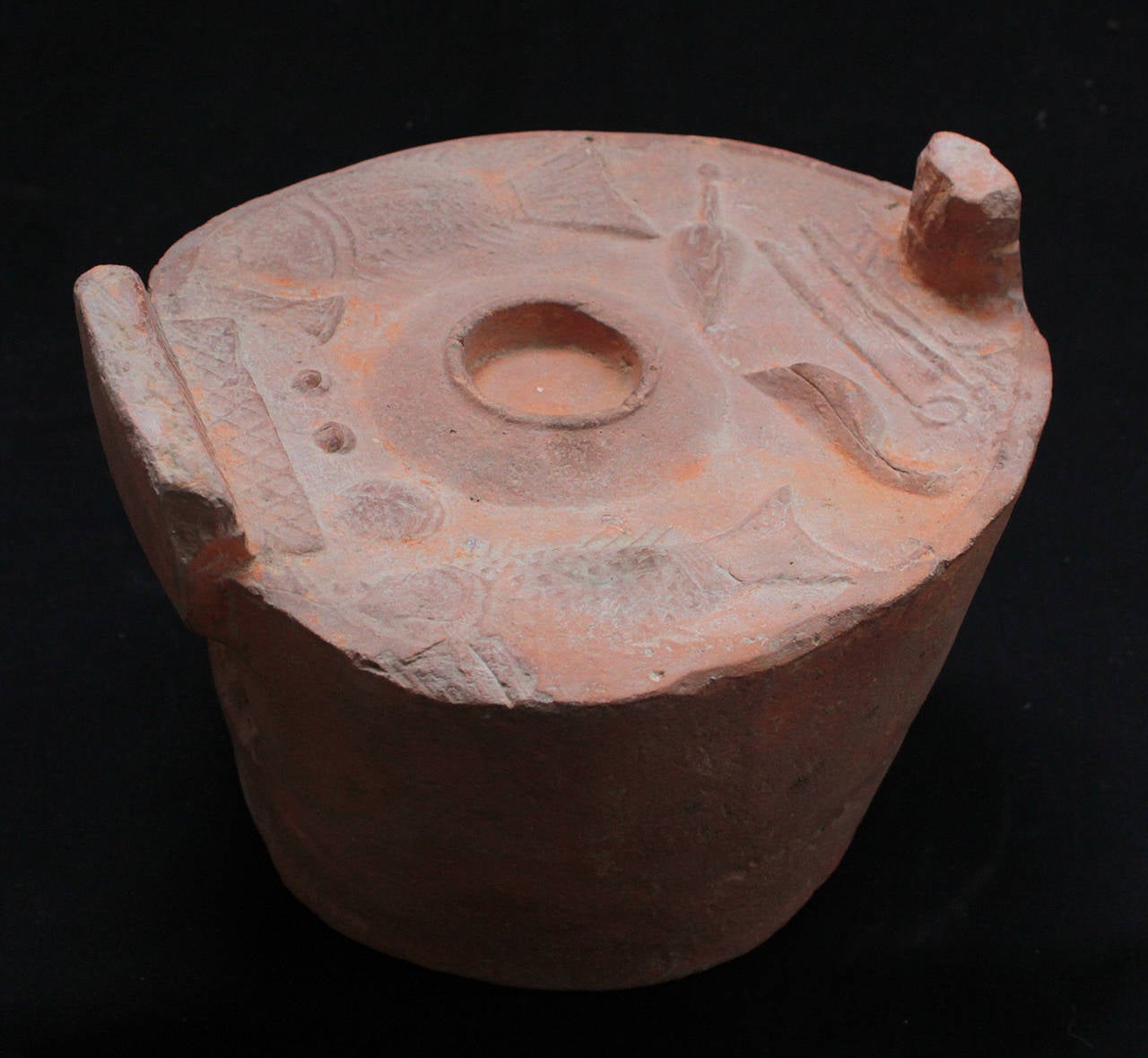 Chinese terracotta pottery model of a stove, shown with a central cooking pot and a selection of foods including a duck, two large fish, as well as cooking implements such as spoons, bowls, and a knife, the fire hole with an ornate opening.         