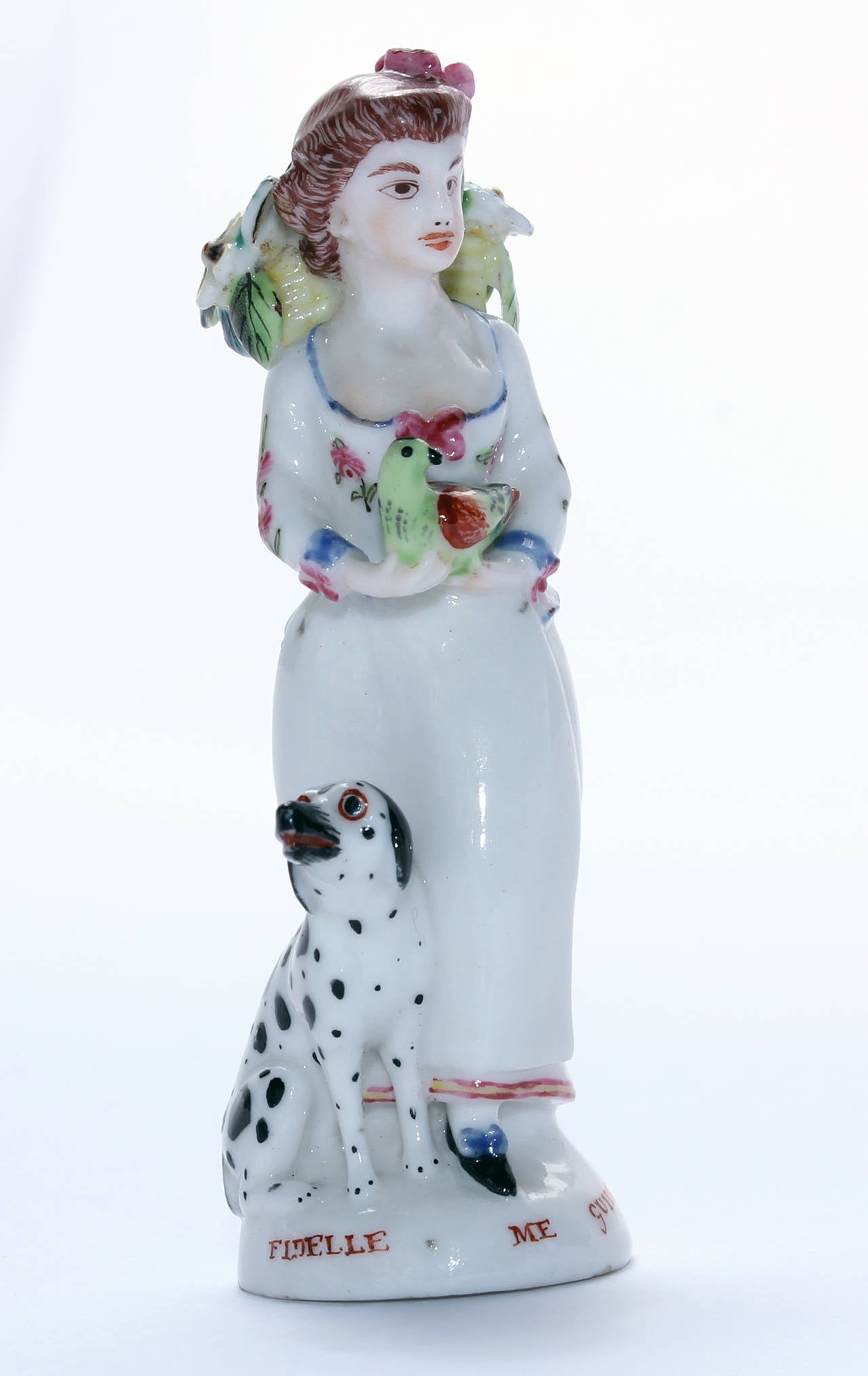 St James scent, modelled as a lady with dalmatian by her side, a bird clasped in her hand and a wicker basket of flowers to her back, on a low mound base inscribed in red script 