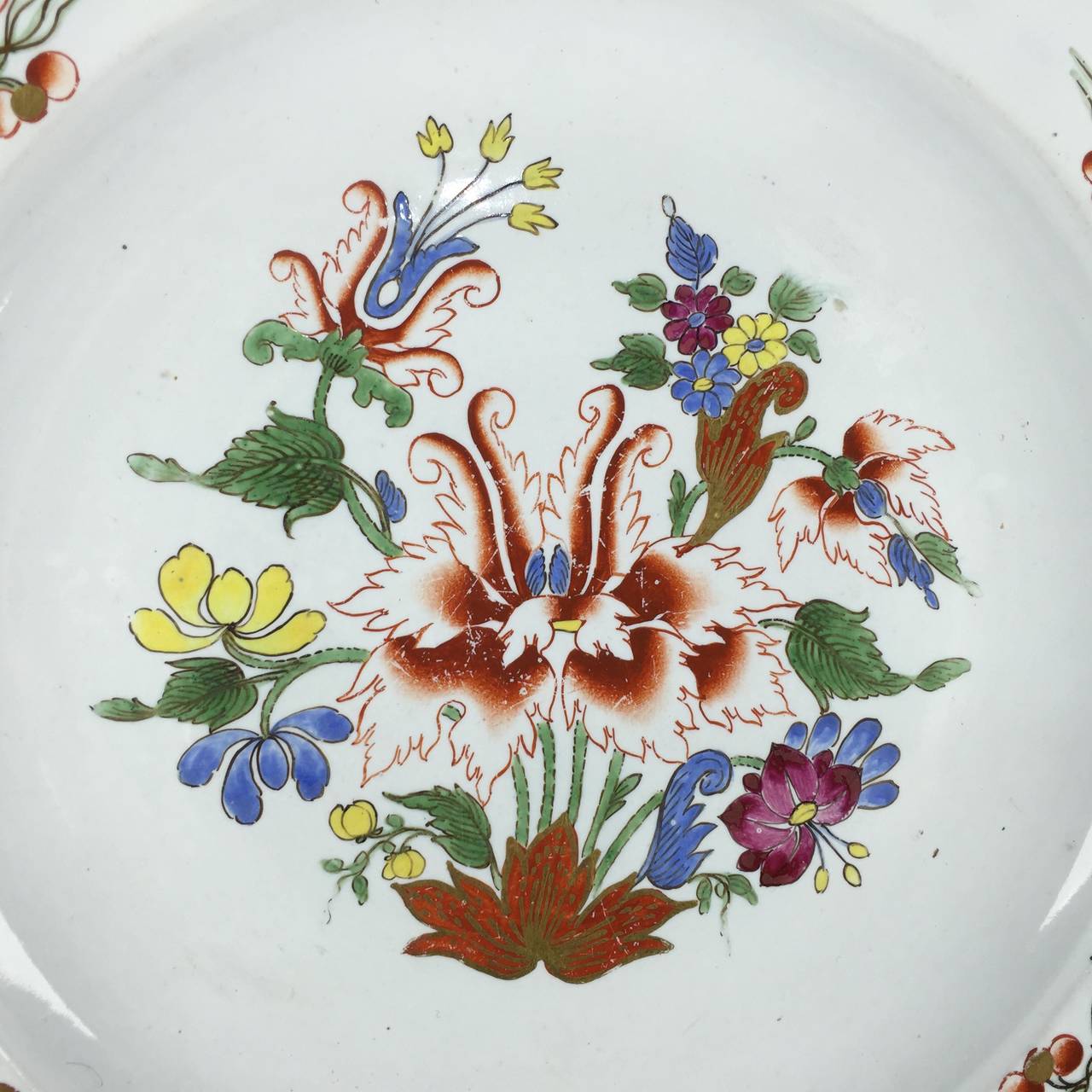 Doccia lobed silver shape plate, boldly painted with a version of the Tulip pattern, with large central Oriental flowers in iron red, green, blue, yellow, and black, the whole with gilt highlights, the glaze showing use of tin oxide to hide the grey