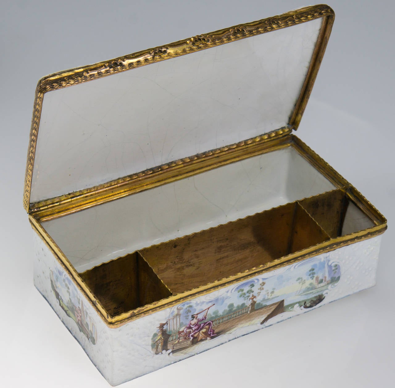 Rare large English enamel writing casket, the interior with gilt copper divisions for inkwells etc., the outside with a white-on-white raised diaper pattern and rococo framed panels brightly painted with classical landscapes including figures and