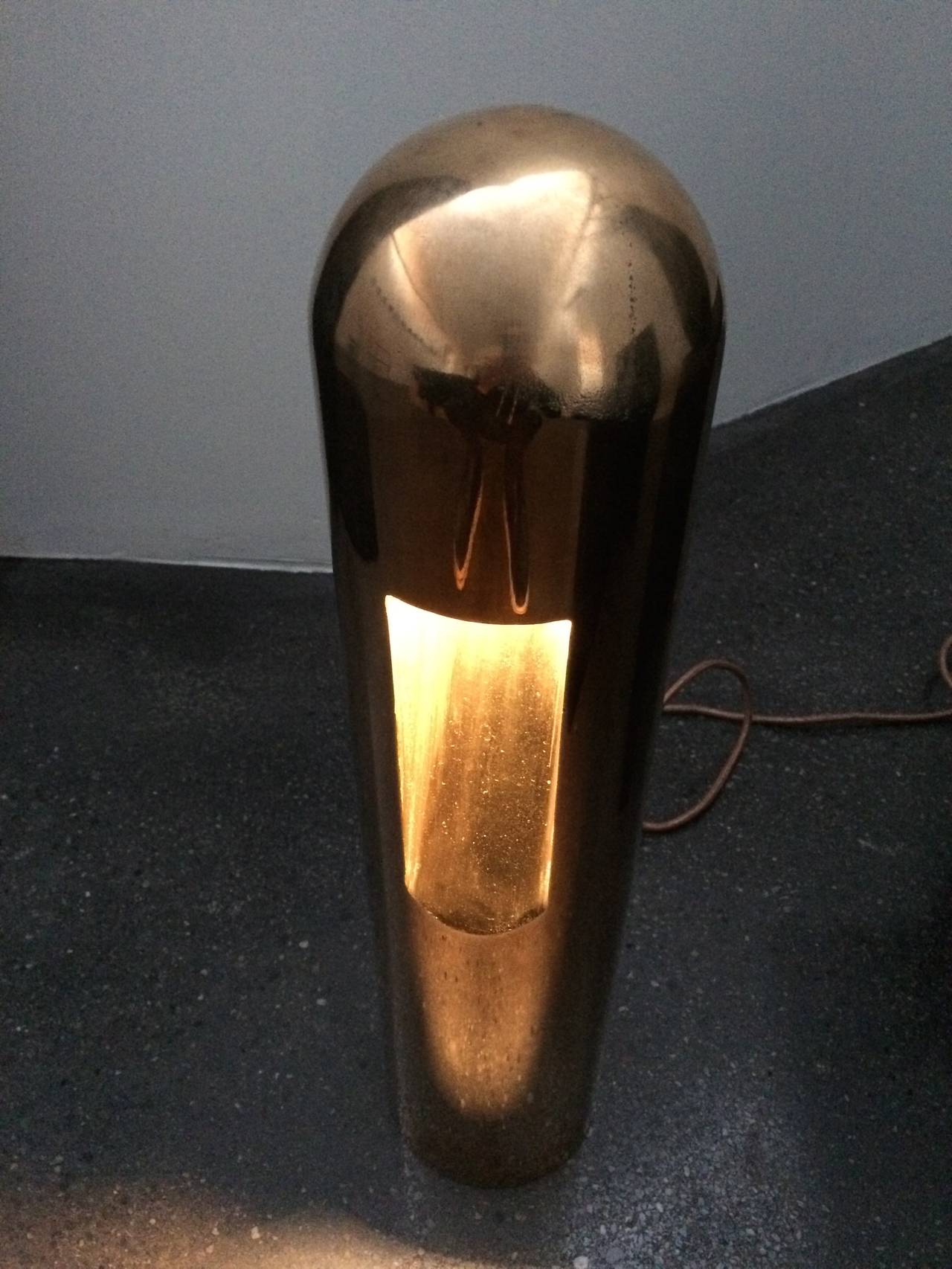 Rick Owens home collection.

Cylindrical polish bronze lamps with a rounded top; concave slope serves as a reflector for the inset LED light source.

Material: Polished bronze.

Dimensions:
6 W x 6 D x 23.5 H in.
15 W x 15 D x 60 H