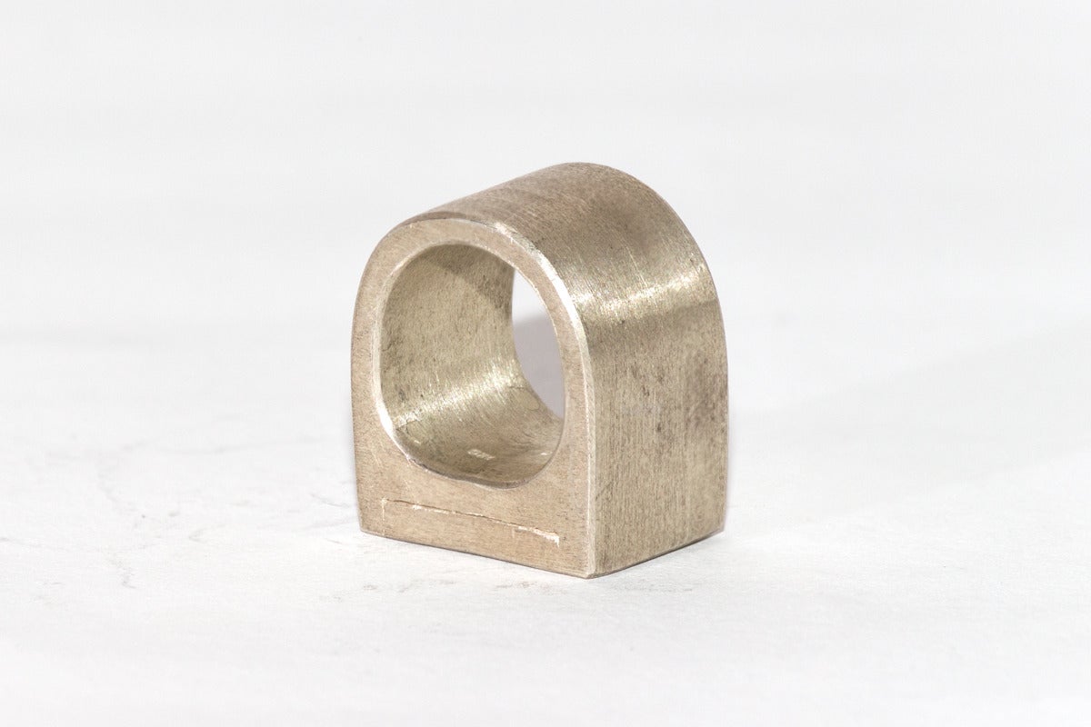 Raw diamond inset into sterling silver casing/ring.