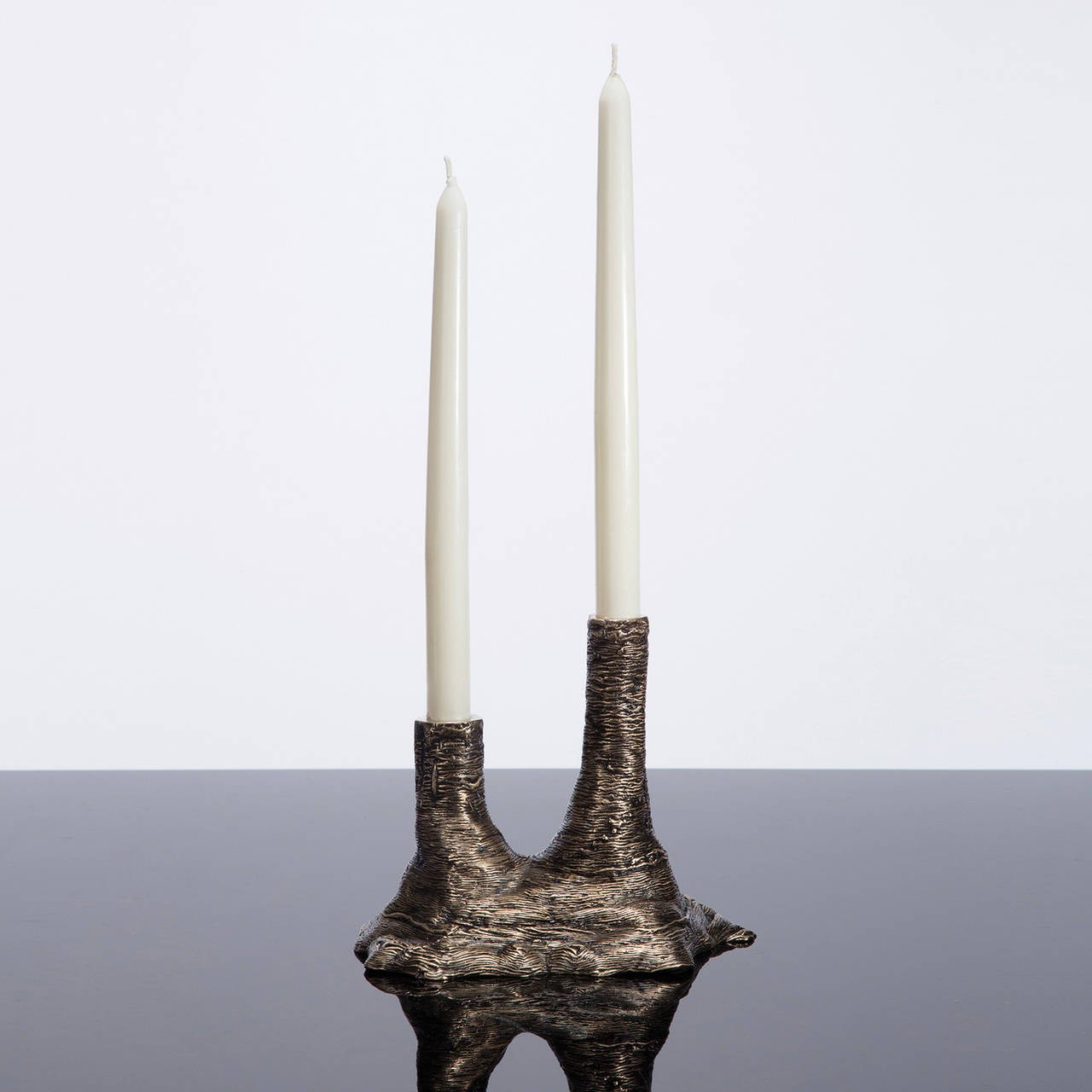 Ice-Cast Bronze Double Candleholder by Steven Haulenbeek available from LMD/studio. 

Each vessel or object is hand casted in bronze using Haulenbeek's trademark 