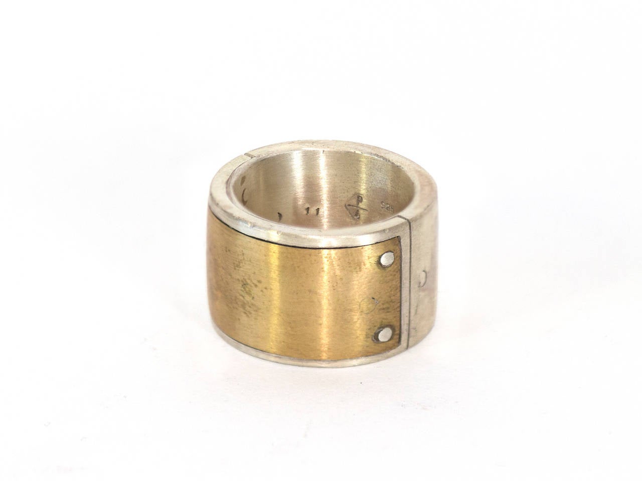 Sistema Ring – 17, by P/4 in matte sterling and matte brass. 

Size: 11