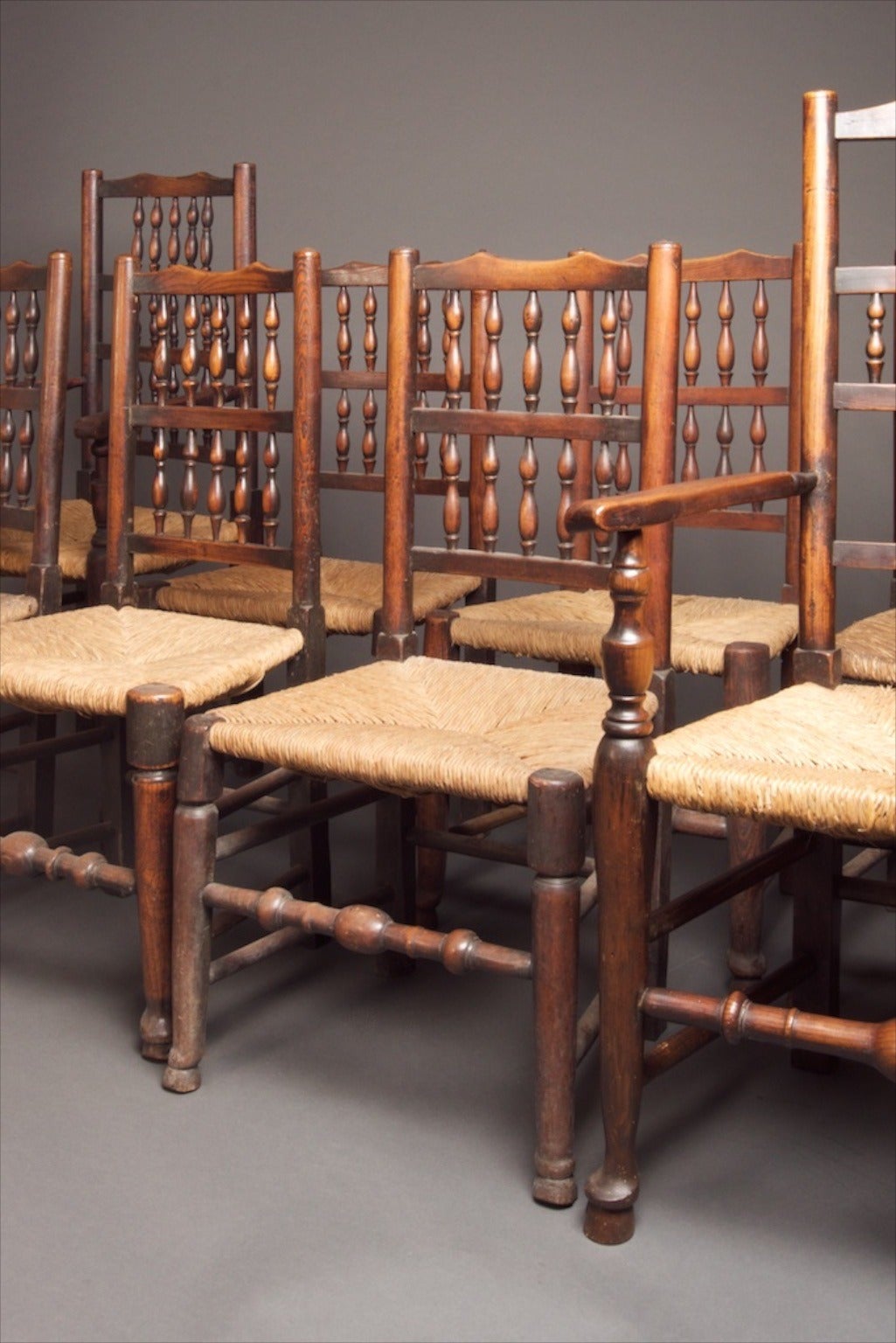 

A mixed set of eight 18th century Lancashire spindle back chairs, includes six sides & two carvers. Beautiful original English country chairs. By a mixed set, this set has probably been assembled over a long period of time & some of the