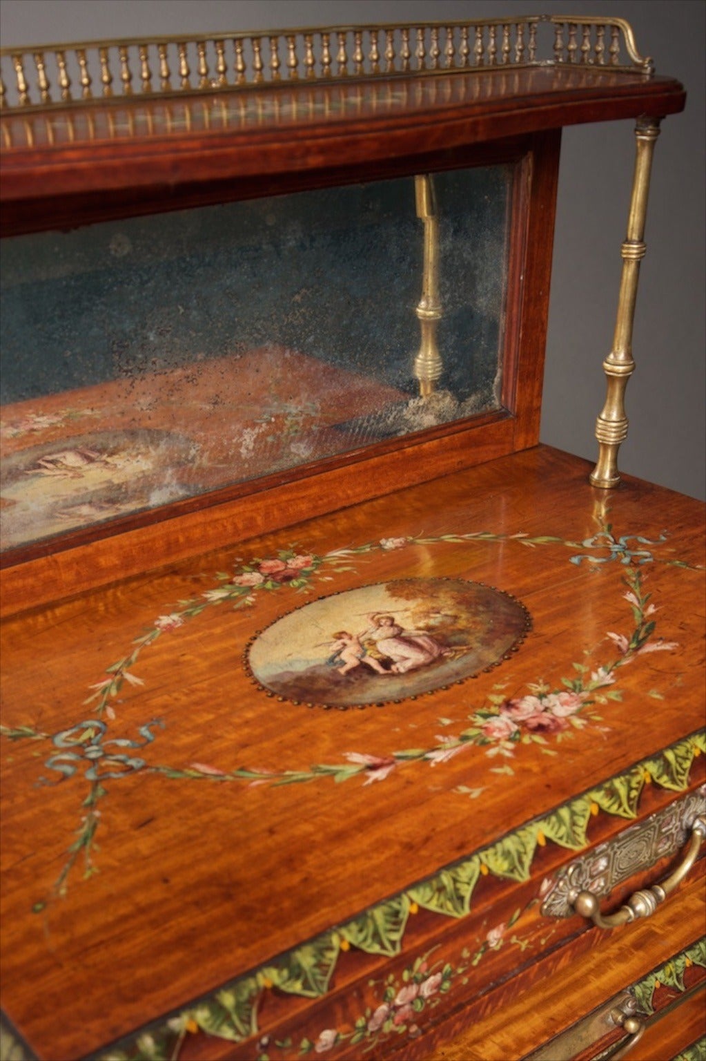 Late 19th century satinwood music canterbury in the Georgian revival style. The painted decoration in the manner of Angelica Kaufmann.