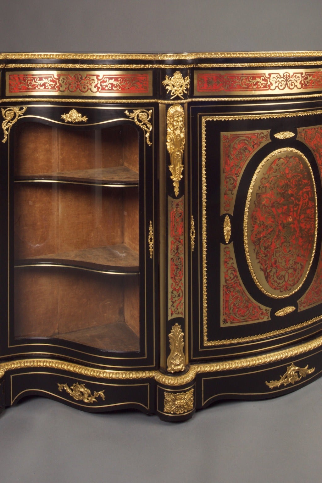 Antique, Third Empire Boulle side cabinet, France, circa 1870.
23,850.00.

A large side cabinet, the cupboards at either end having serpentine glass doors with two display shelves, there is a large cabinet to the middle of the side table. Being