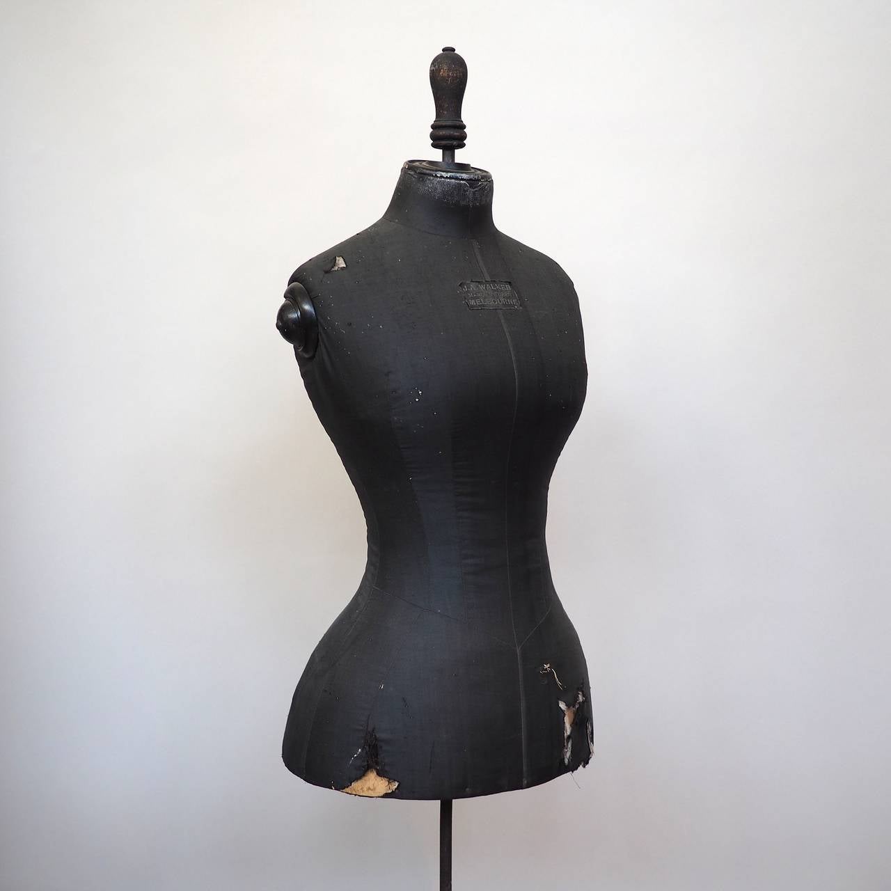 silk-covered bodice, with maker's label for J.A. Walker, Melbourne. Shaped with a tiny waist and bustle, on a black-painted timber stand.