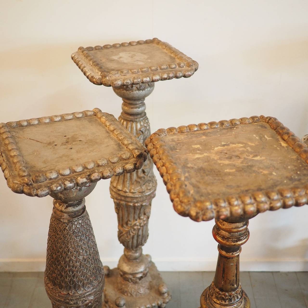 Carved timber pedestals, four painted silver and one gold. These are likely to have been made from ornately-carved balustrade pillars, the top and bases have been added later.

Heights vary from 100-106cm.