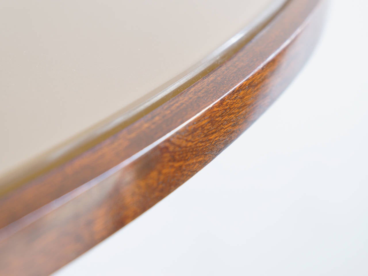 Oval rosewood dining or centre table designed by Guglielmo Ulrich. Glass top in the most beautiful shade of warm champagne, inset from rosewood edge. Pierced Rosewood, brass and marble pedestal base, circa 1940.
