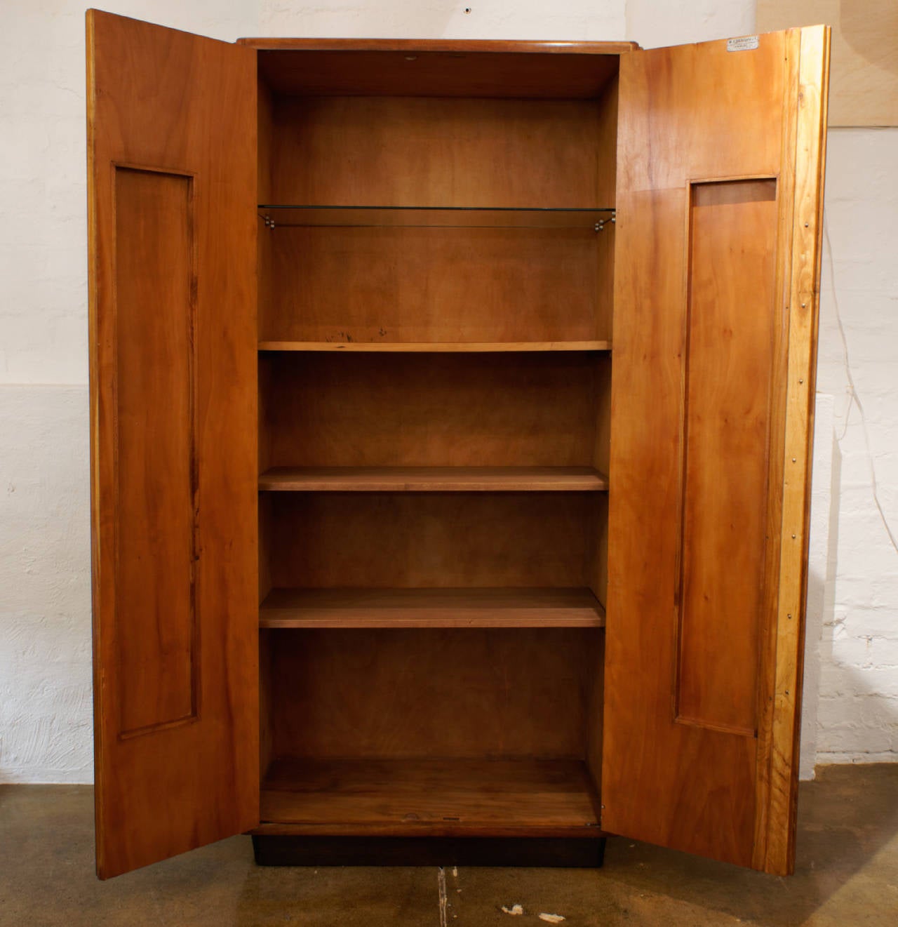 Tall modernist oak cupboard manufactured by R Cabellini & Co, Como, Italy. Makers plate on inside of door. One glass shelf and three wooden shelves, original brass key, circa 1930.