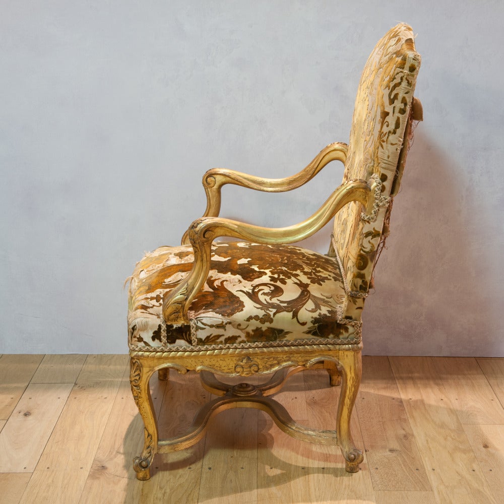 19th Century Gilded Armchair The Domed Upholstered Back Sprung Seat Whip Stroke Arms Shaped Skirt And Cabriole Legs Finely Carved And Gilded