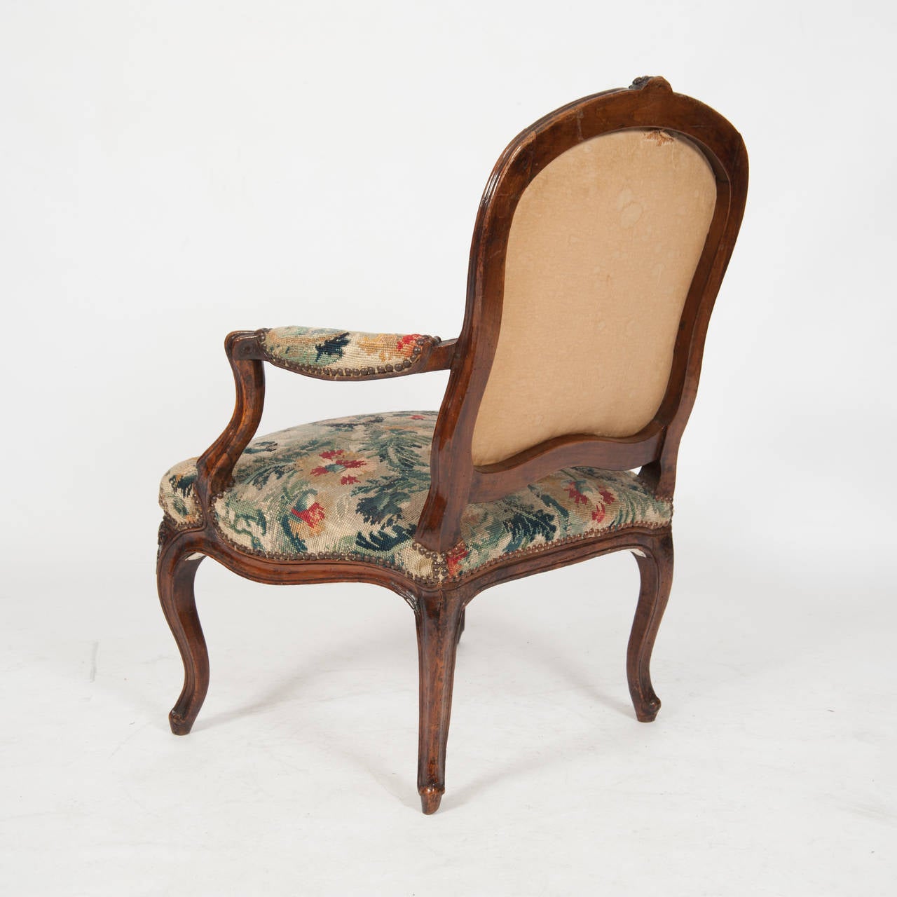 French circa 18th century Louis XV Period Fauteuil The Cartouche Shaped Back With A Central Floral Crest Above Whipstroked Arms The Serpentine Fronted Seat Above A Shaped Rail On Cabriole Legs Upholstered On Wool And Silk Petit-Point Circa 1770 H940