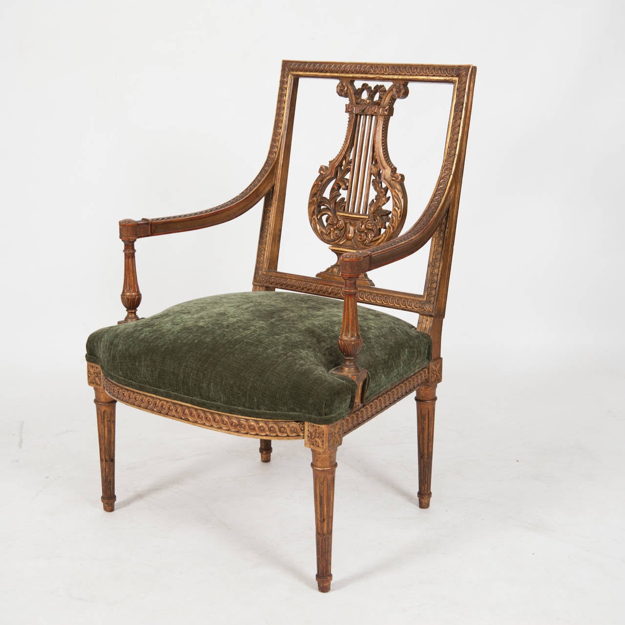 A superb pair of French finely carved LXVI style armchairs with a Lyre splat back in deep bronze green and parcel gilt, circa 1870. Measures: H 885, L 580, D 540.