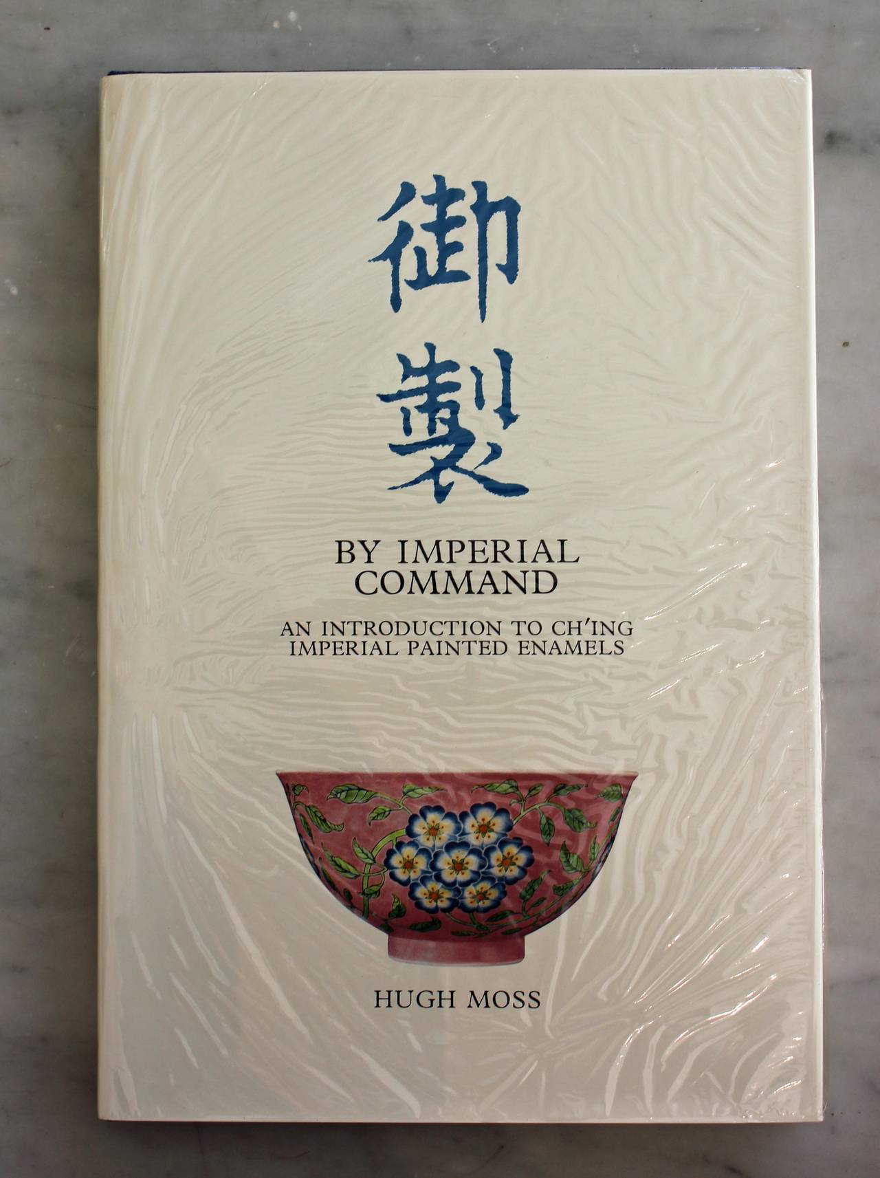 Moss, Hugh by Imperial Command an introduction to Ch'ing Imperial Painted Enamels. 

Hong Kong: Hibaya Company, Ltd.

Two volumes. 87 color photographic plates with 174 images depicting the front and back of each piece. 

Original cloth,